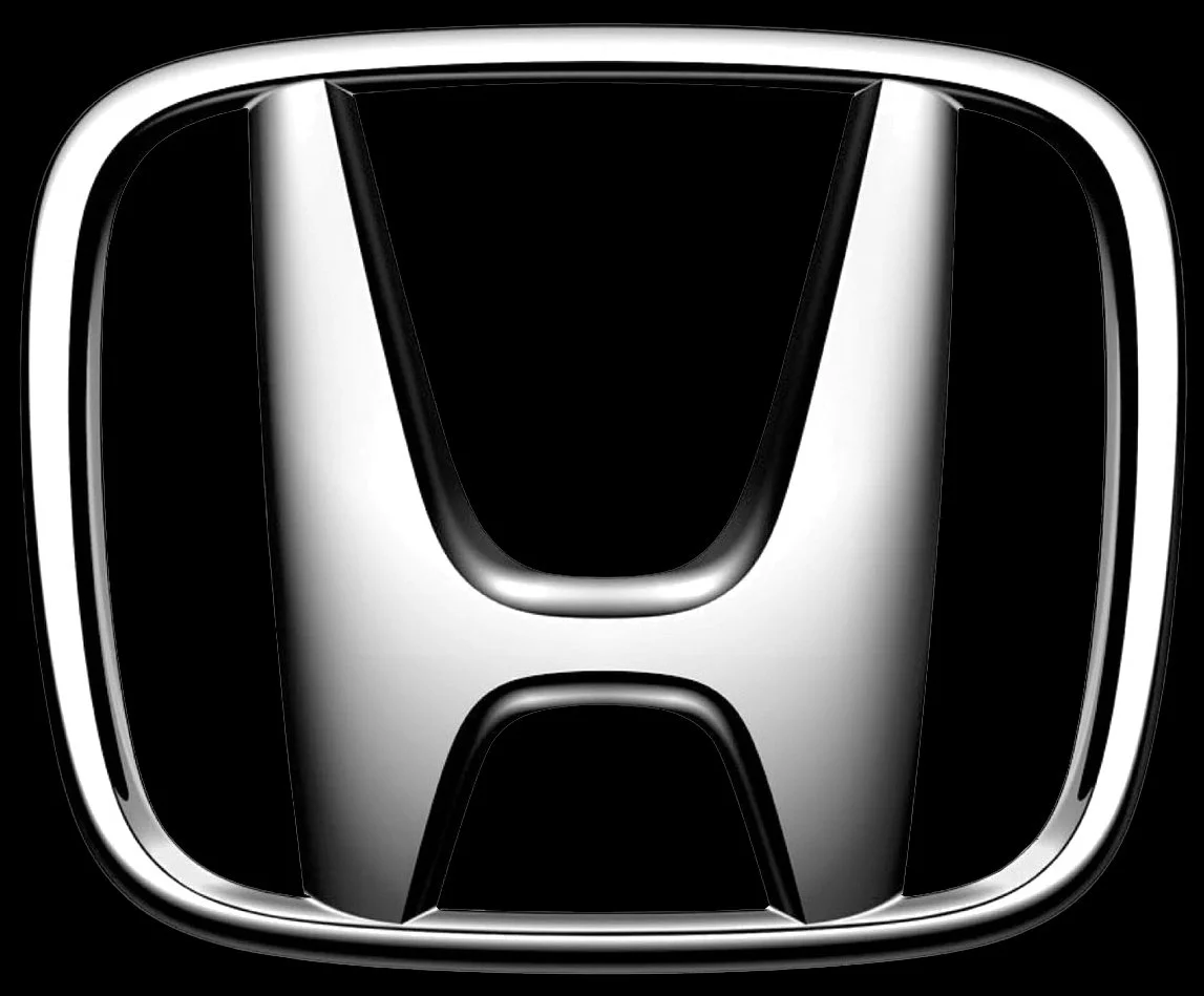 Close-up of Honda logo in black, white, and silver.