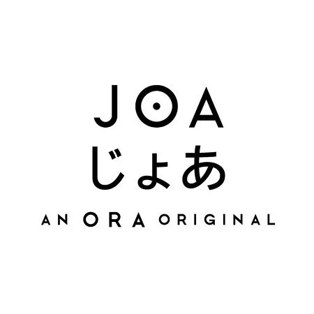 Text displaying 'JOA' with Japanese characters and the phrase 'AN ORA ORIGINAL' underneath.
