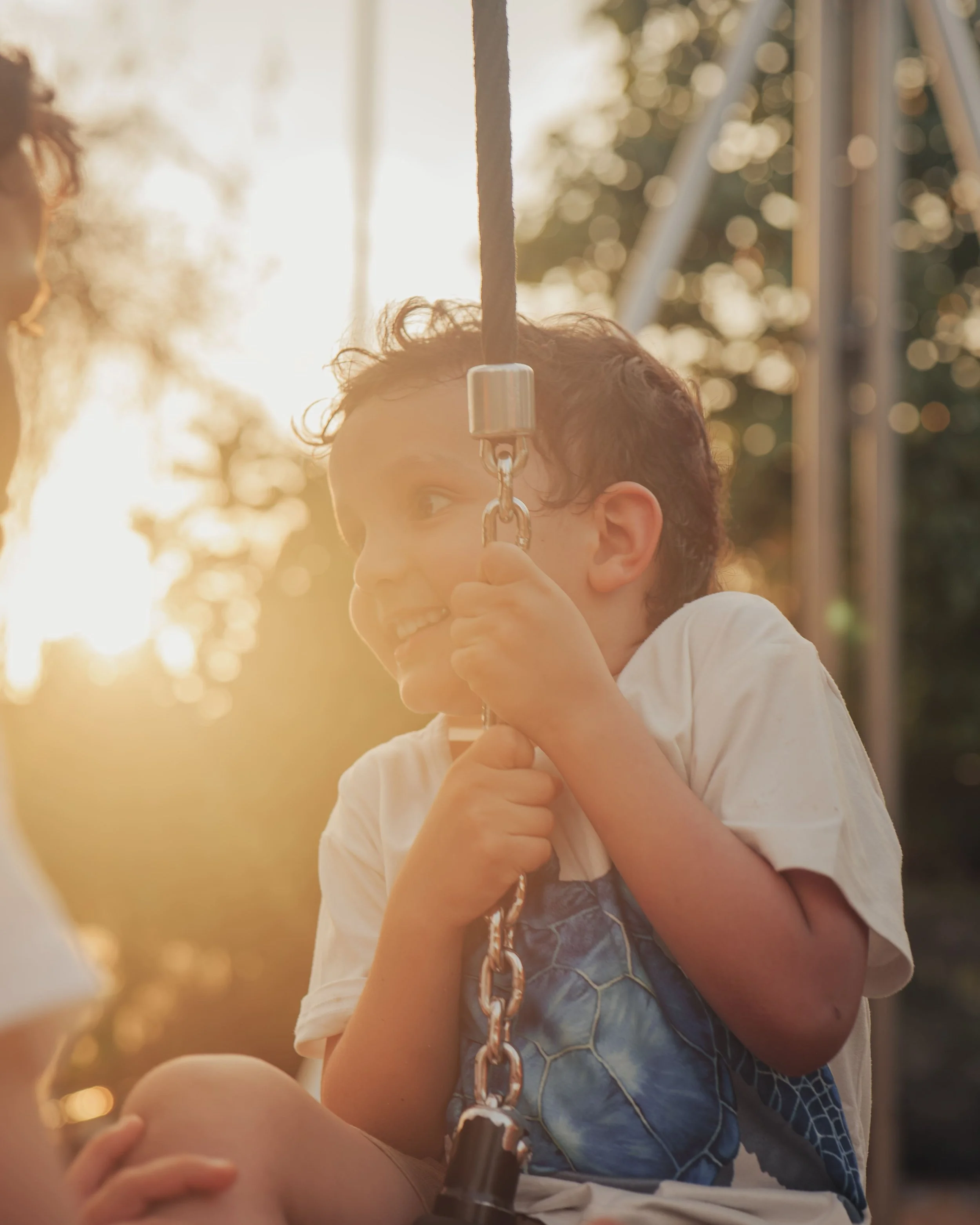 young kid on zipline during sunset