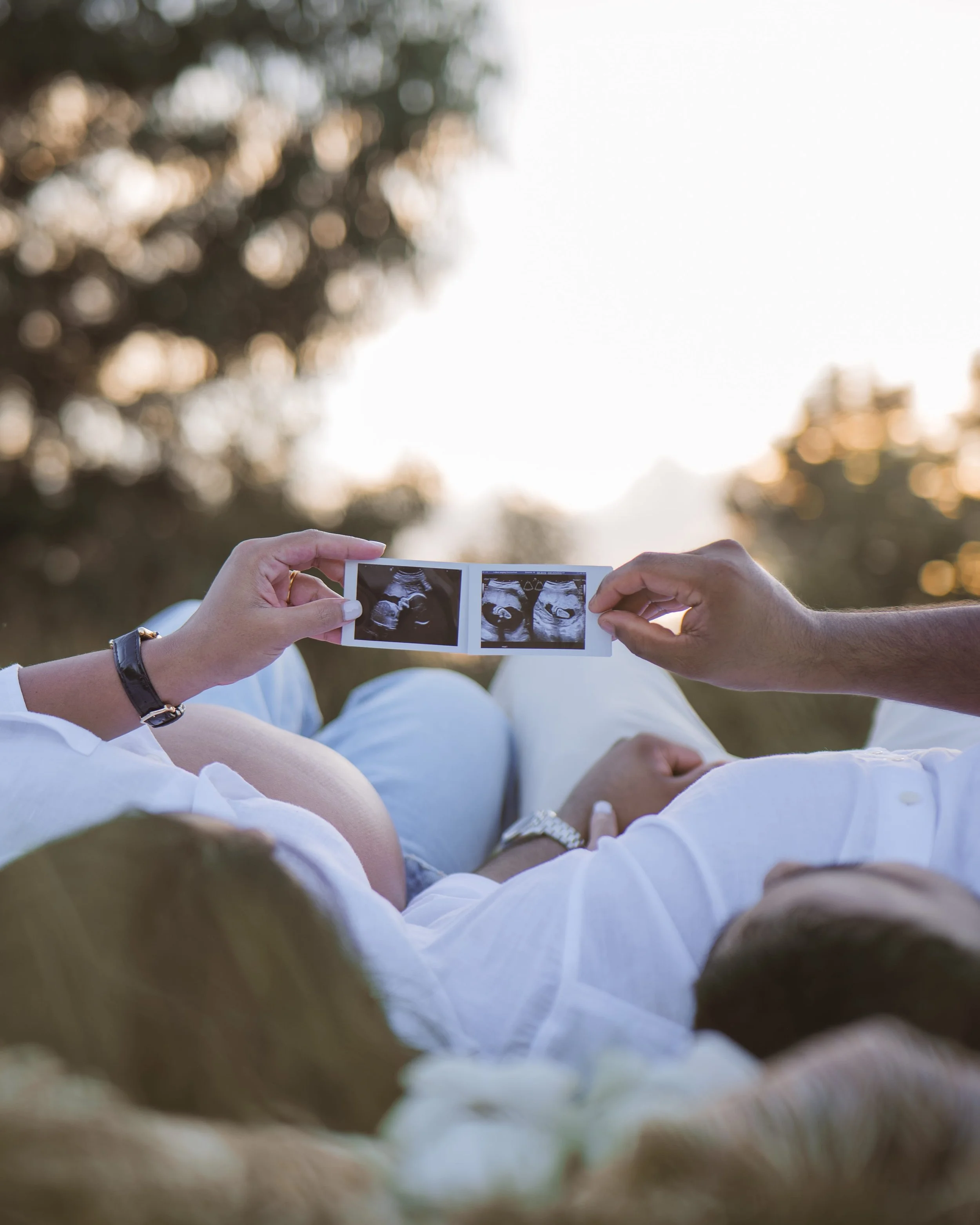 couple looking at ultra sound baby image