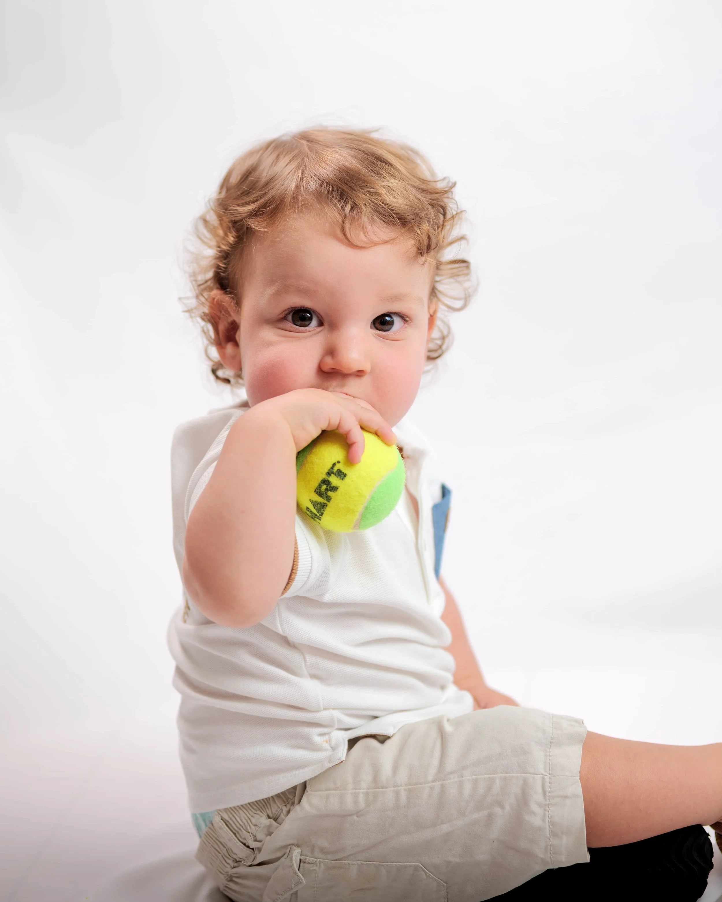 young boy holding tennis ball