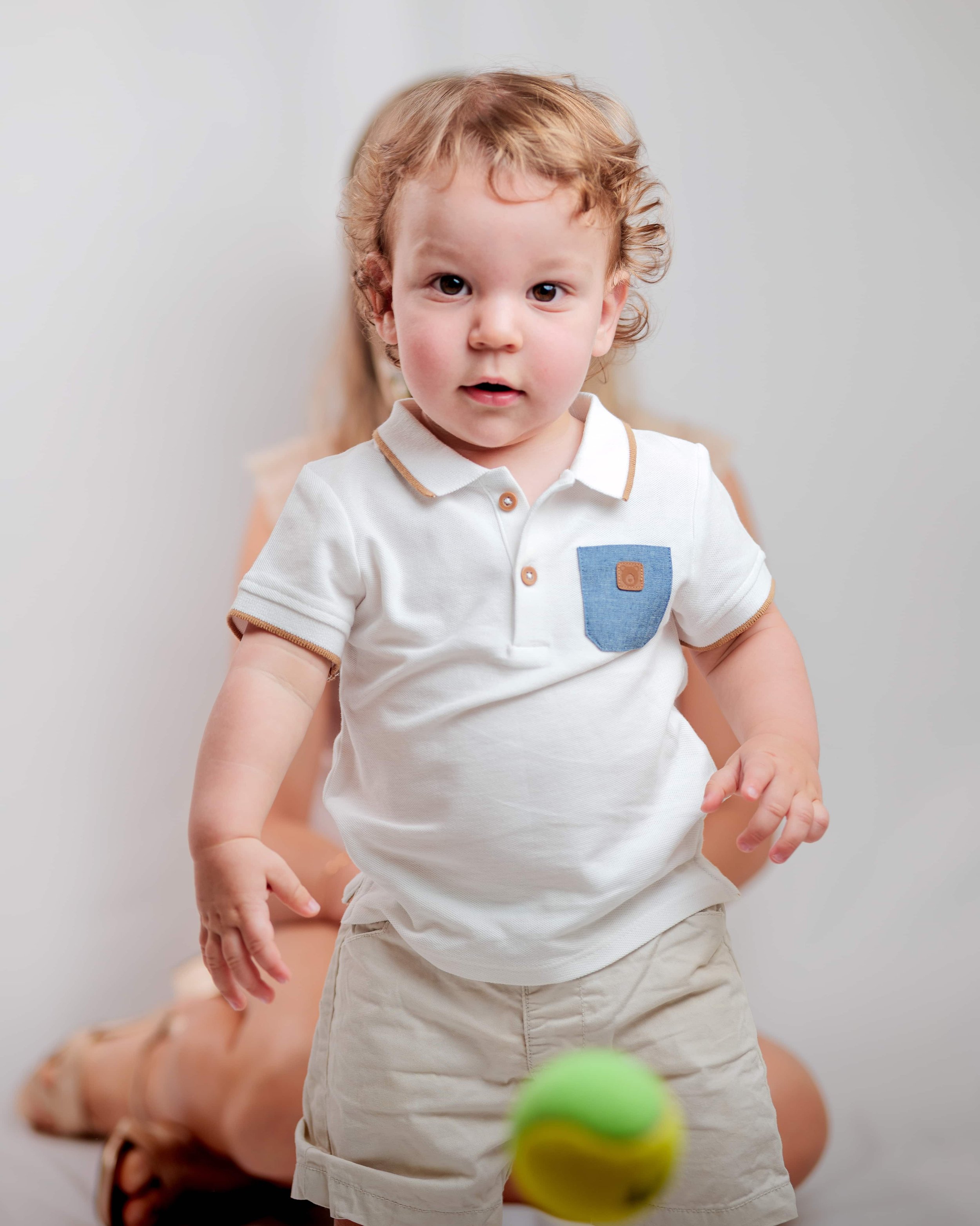 baby boy playing with tennis ball