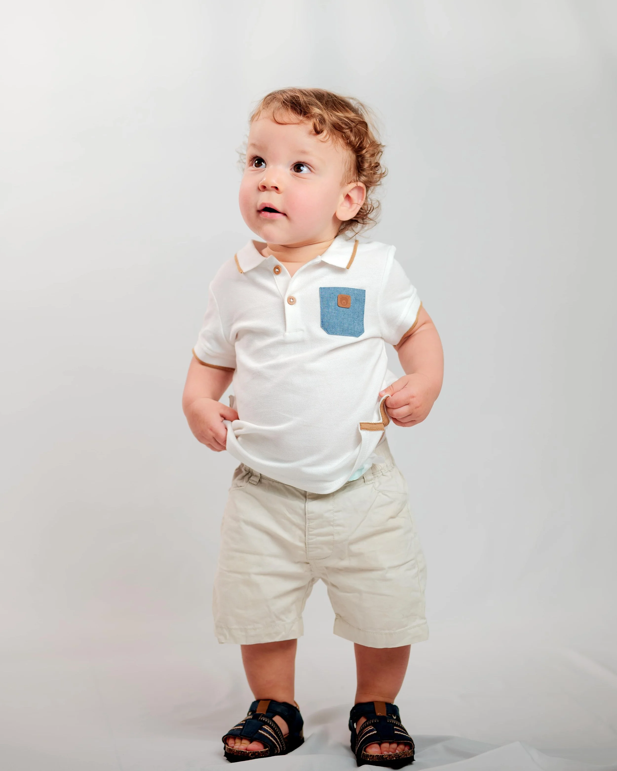 baby boy standing in photoshoot studio