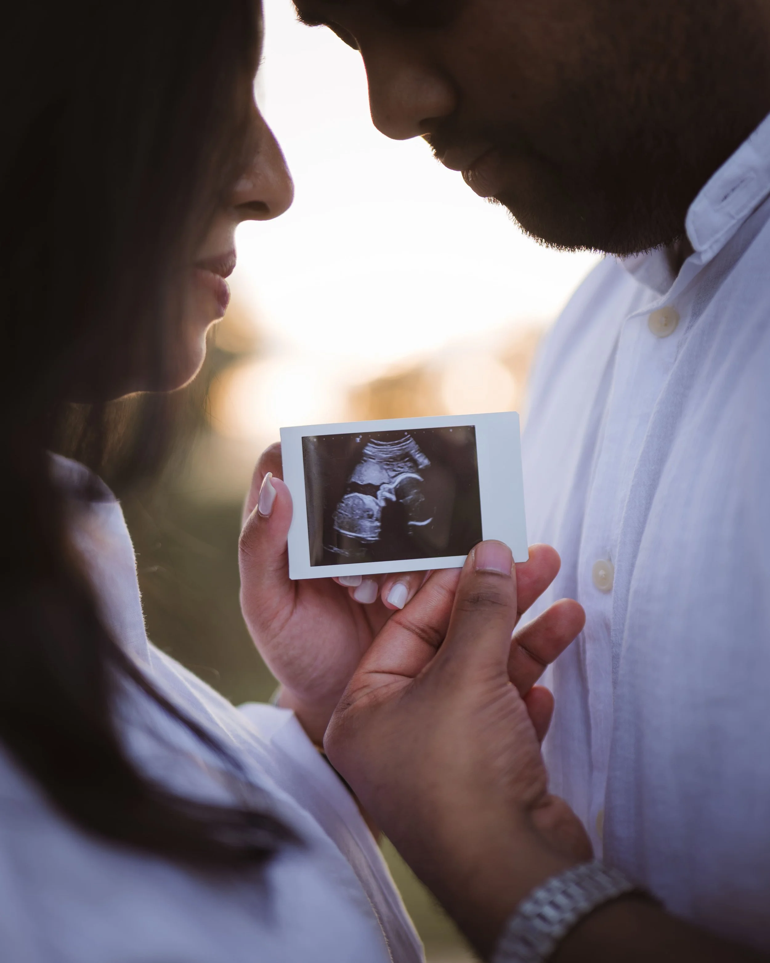 couple holding ultrasound scan