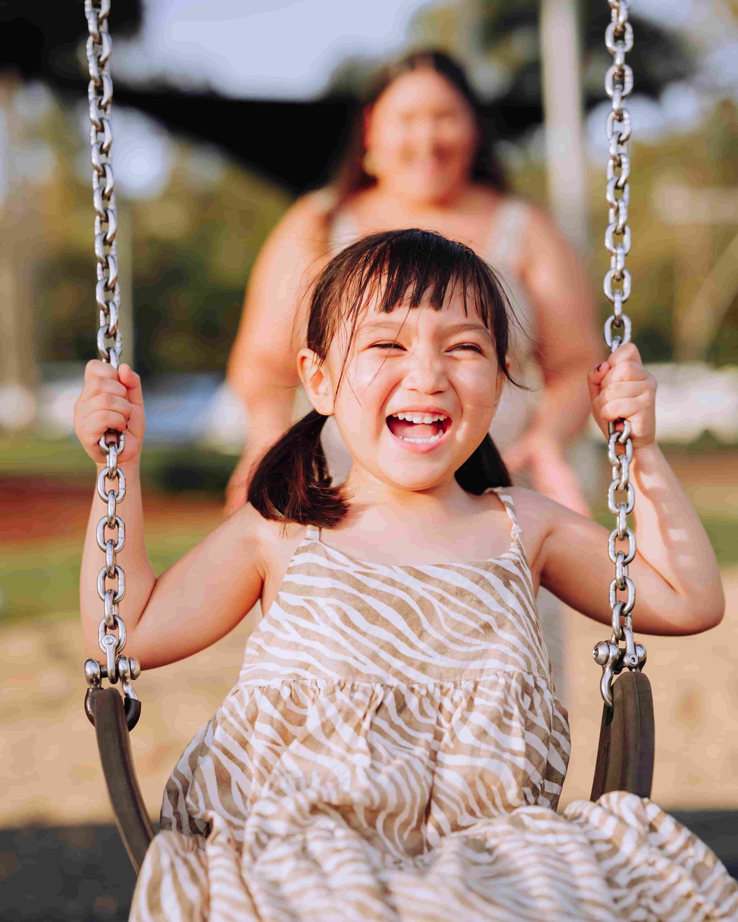 Daughter and mother on swing