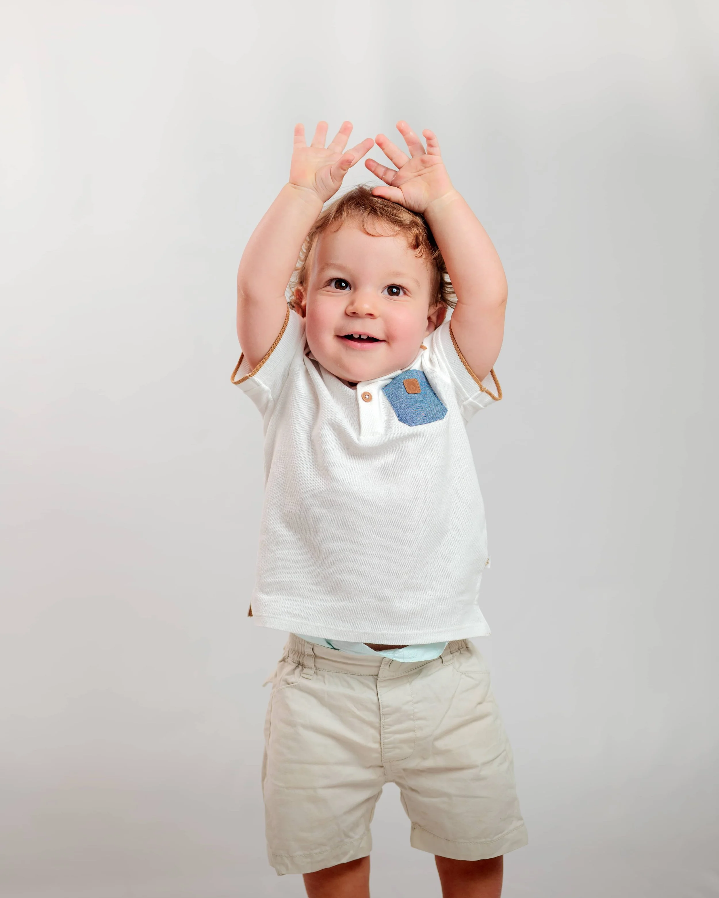 young boy with hands in the air