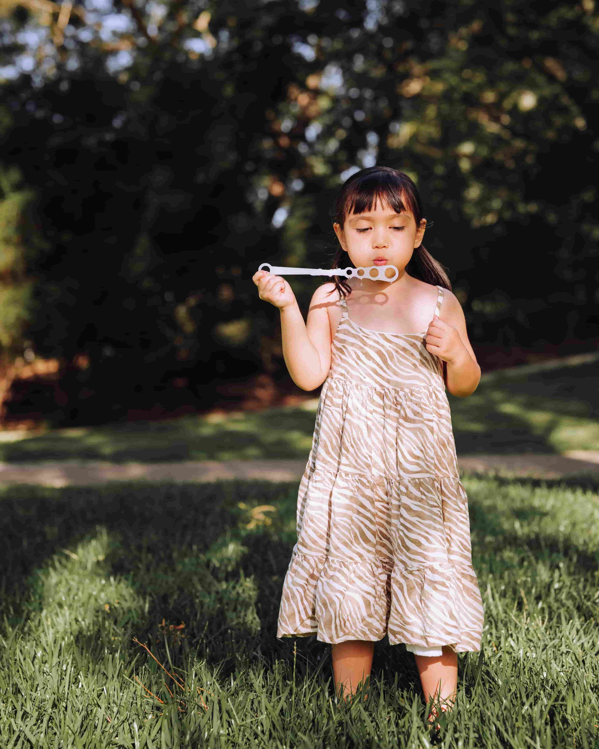 child blowing bubbles