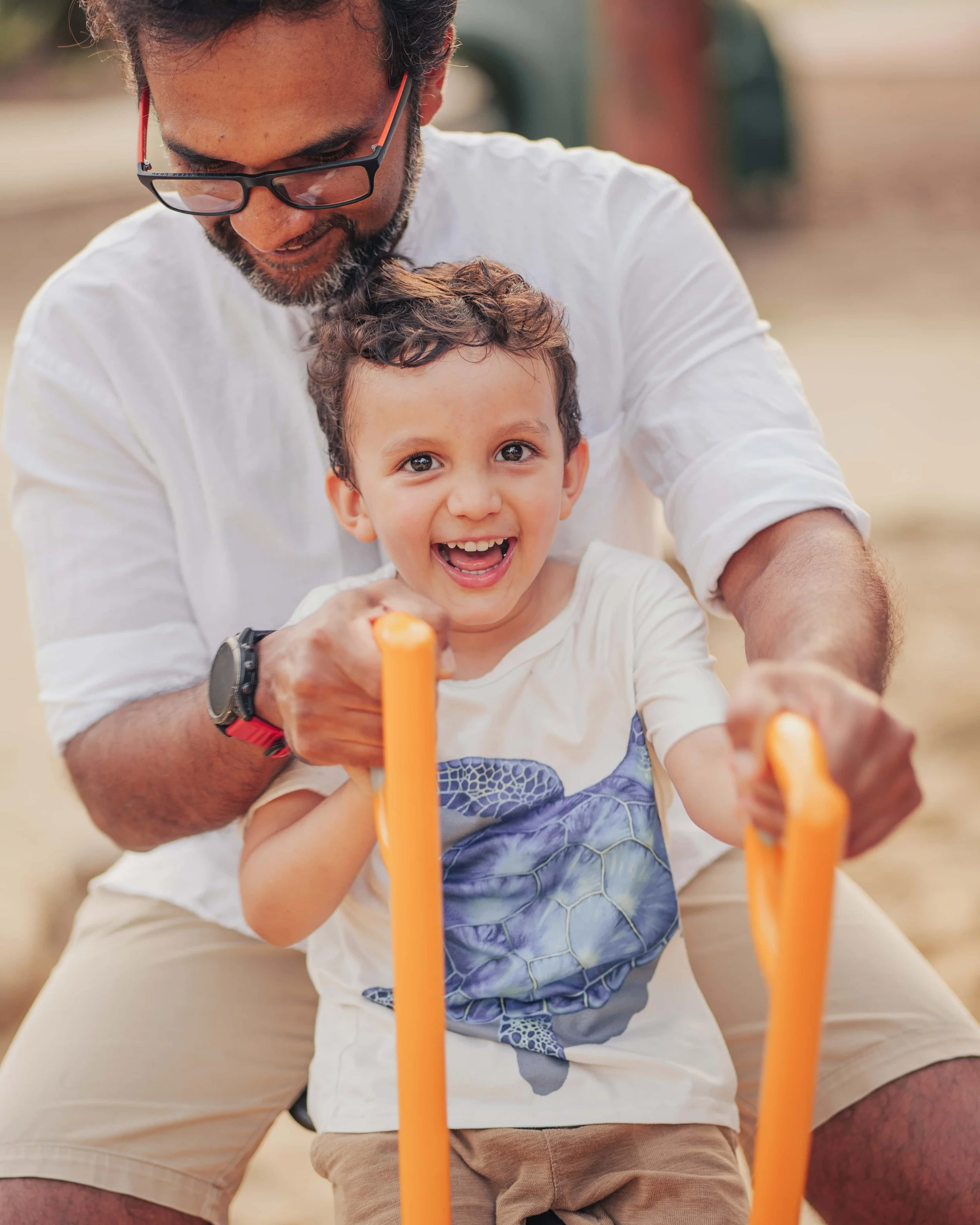 young boy playing with father