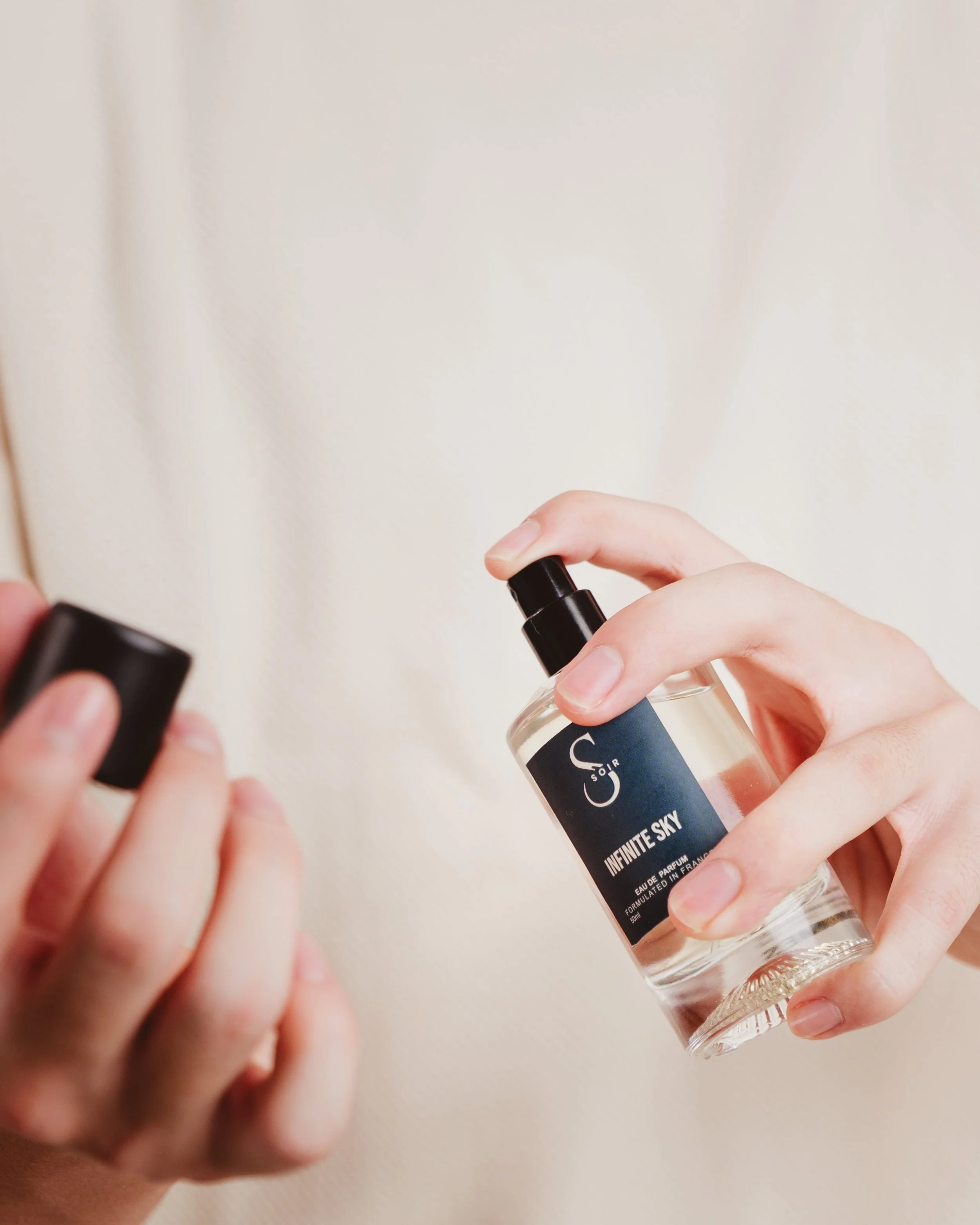 man putting some fragrance on its wrist