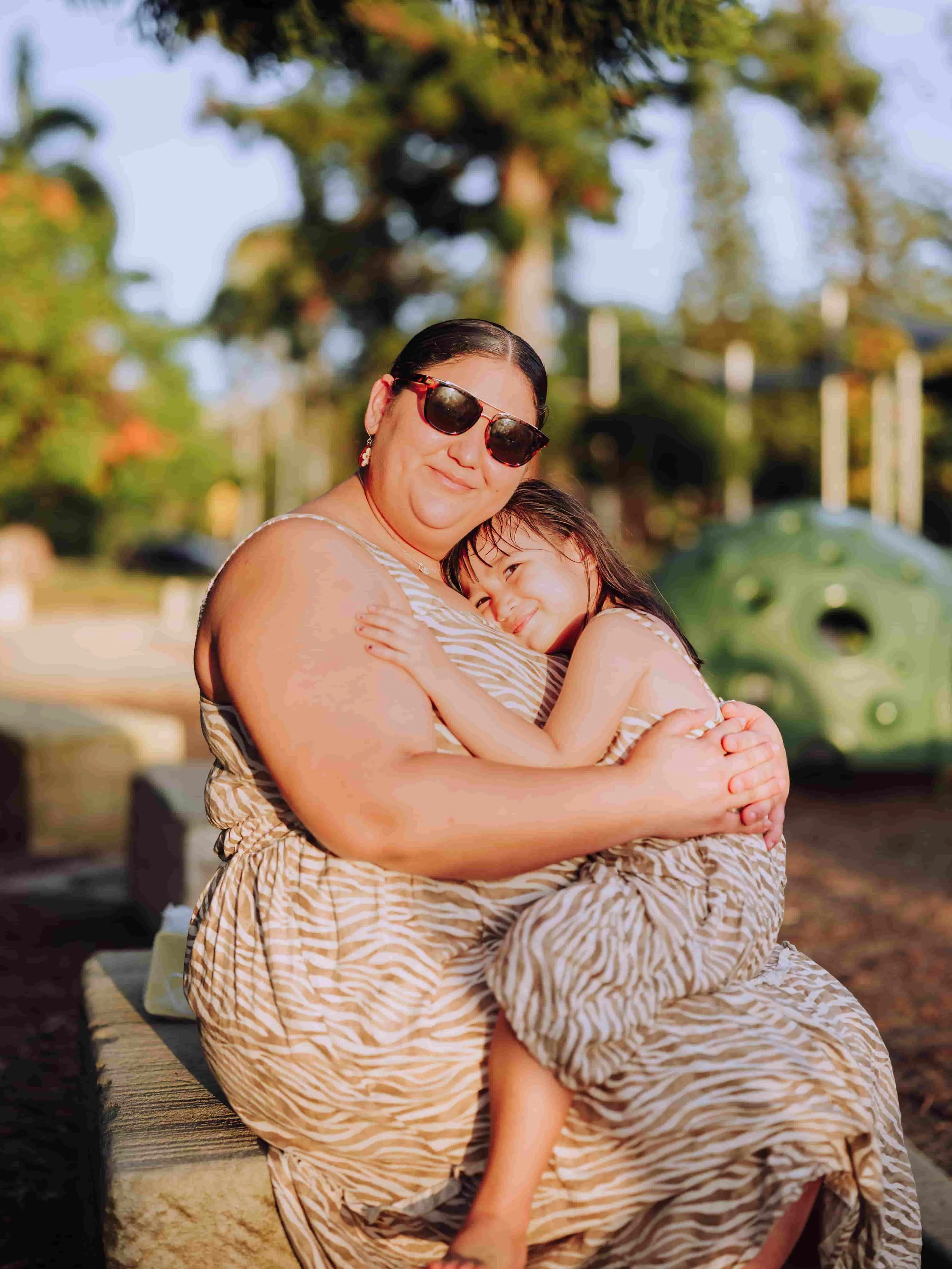 Mother hugging daughter in playground