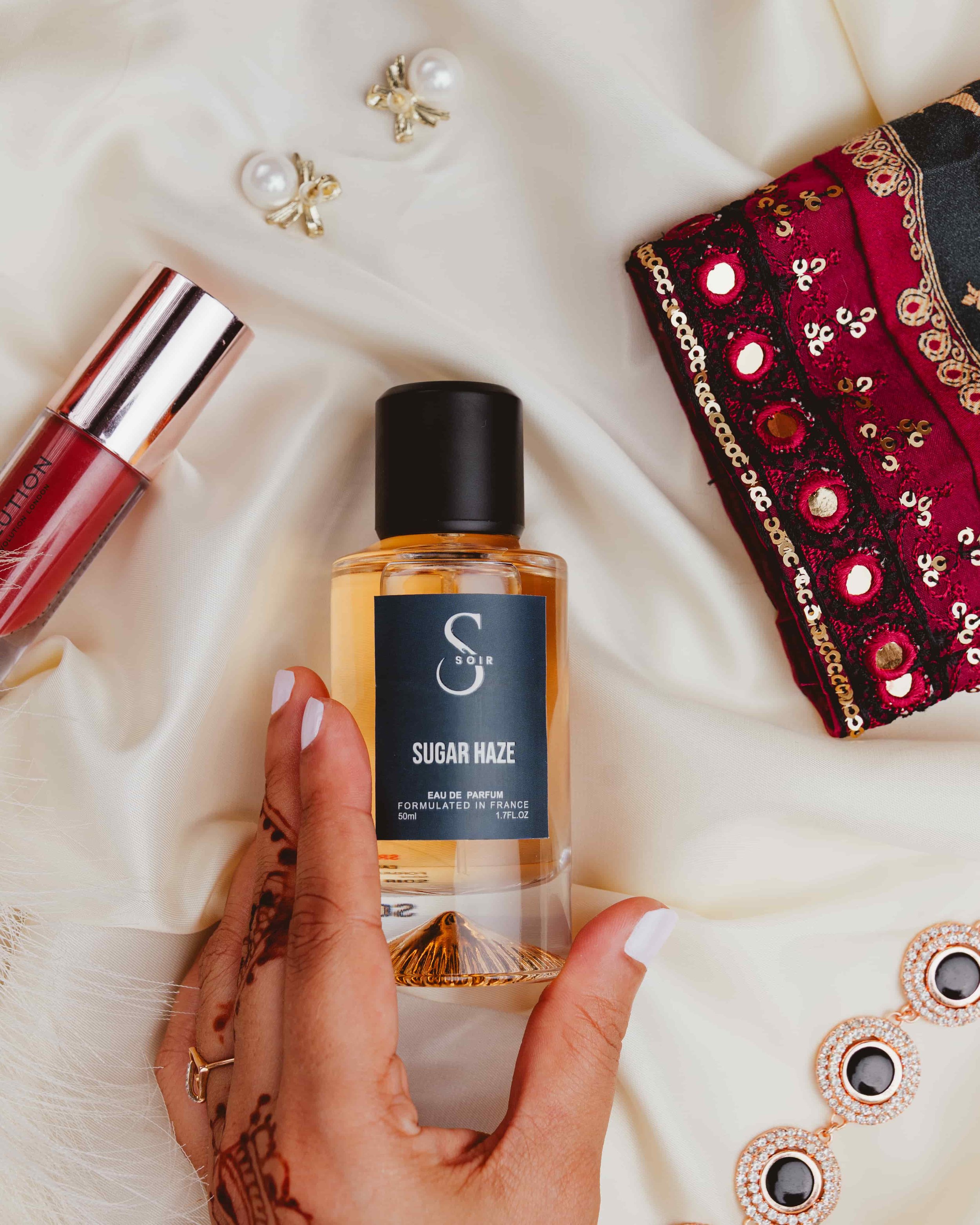 woman hand holding fragrance bottle