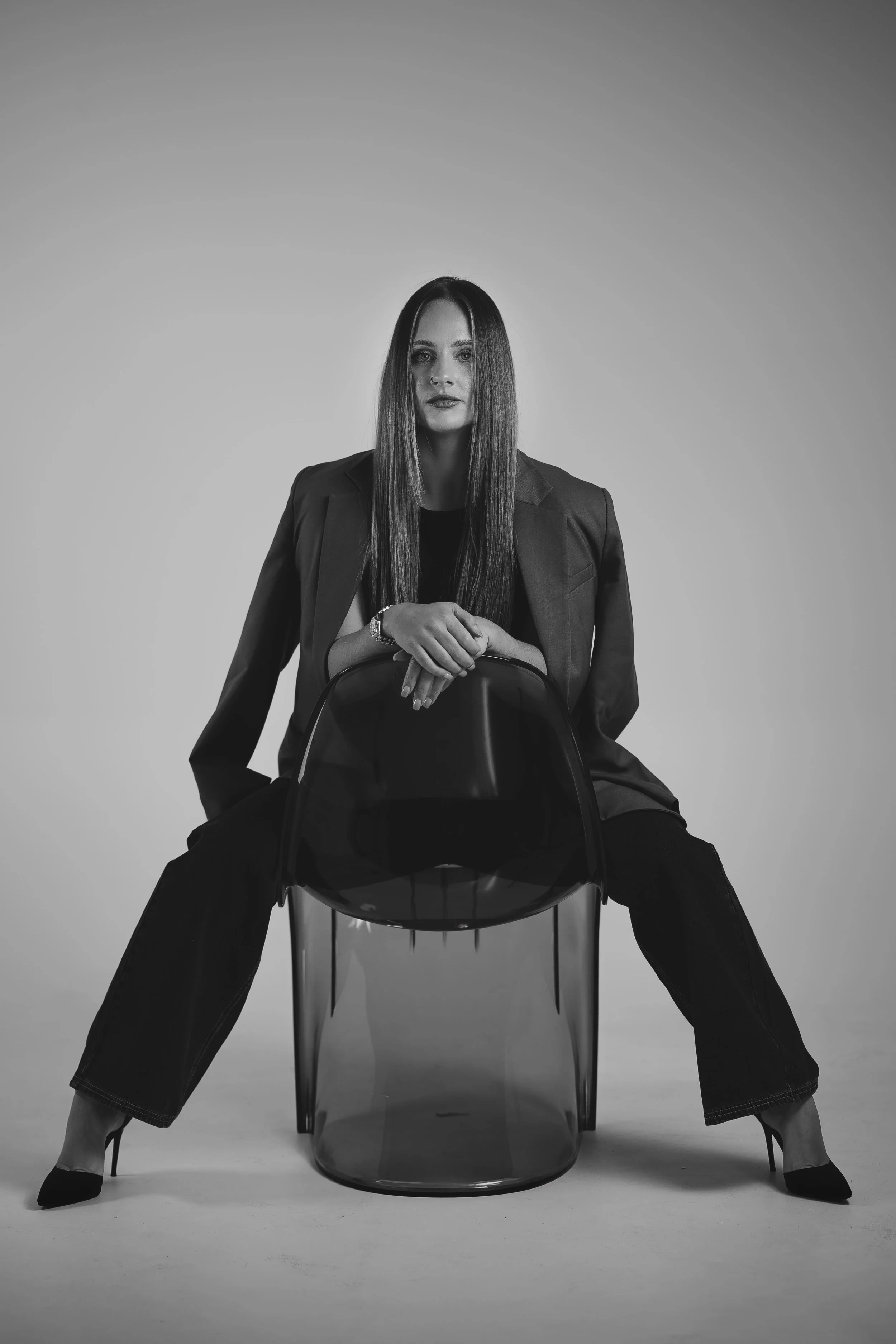 blacka nd white of model sitting in chair