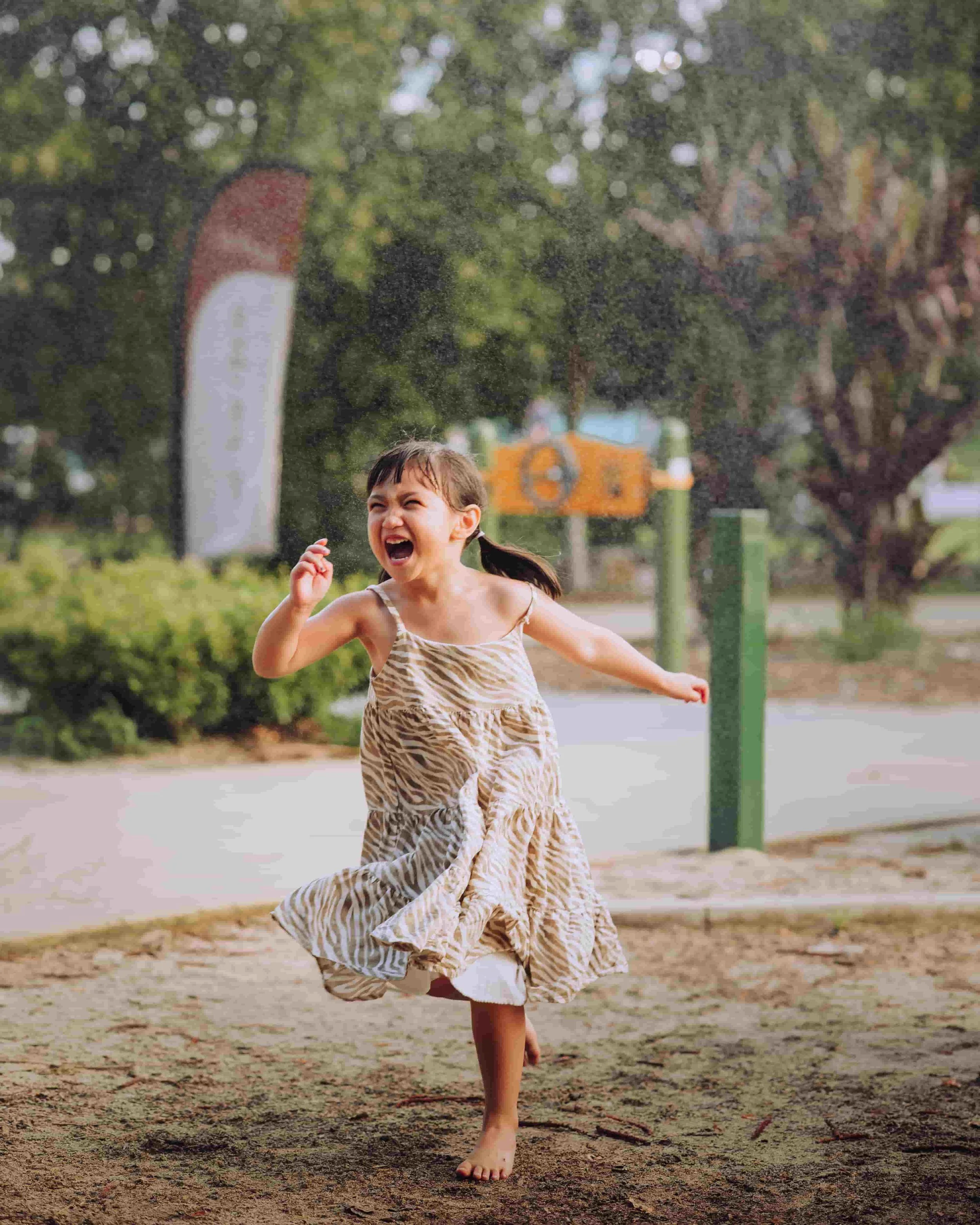 little girl running under rain