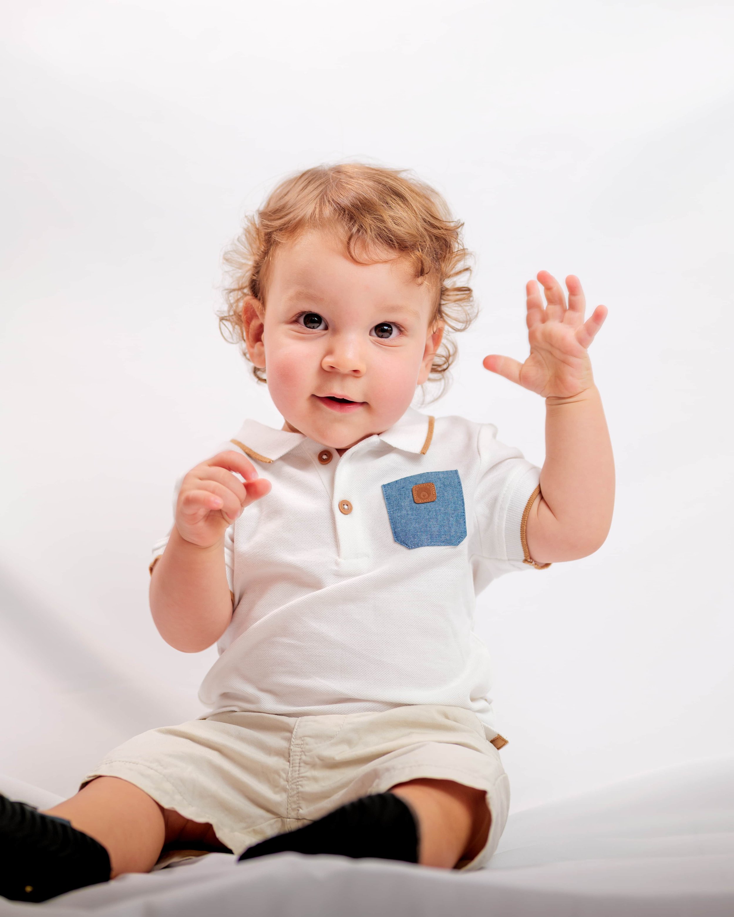young boy with one hand in the air