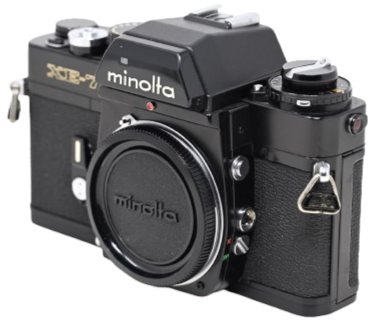 A vintage Minolta XG-7 film camera with a black body and various dials and buttons.