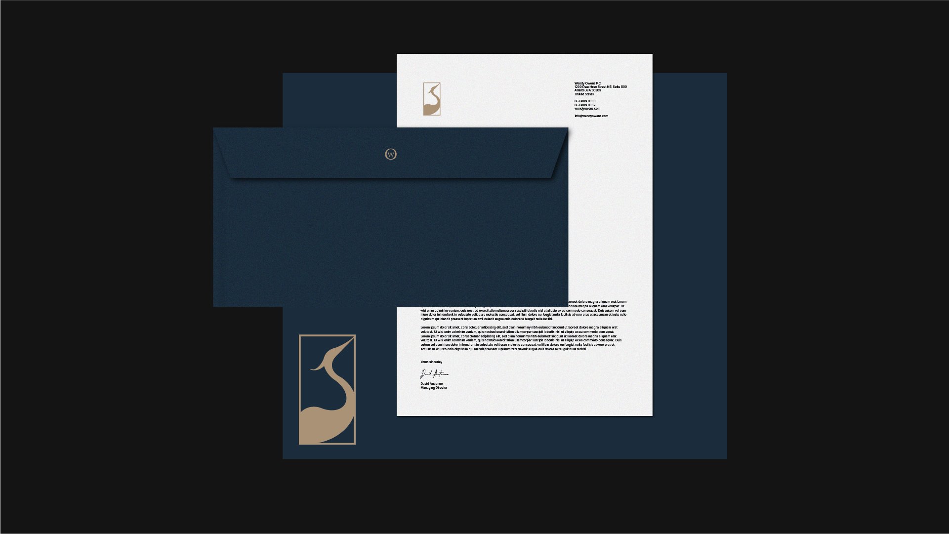 Letter with a navy blue envelope and an open white sheet of paper showing printed text and a signature, alongside a navy blue folder and a business card with a logo of a stylized heron in beige.