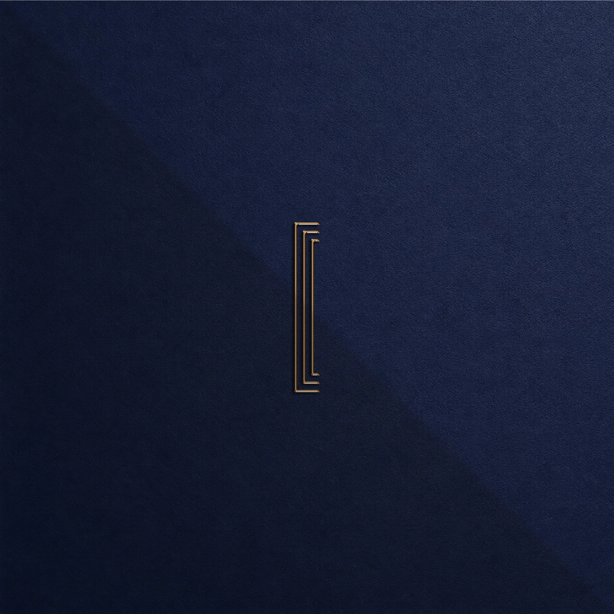 Centered geometric linear monogram debossed in warm metallic gold on dark blue textured paper.