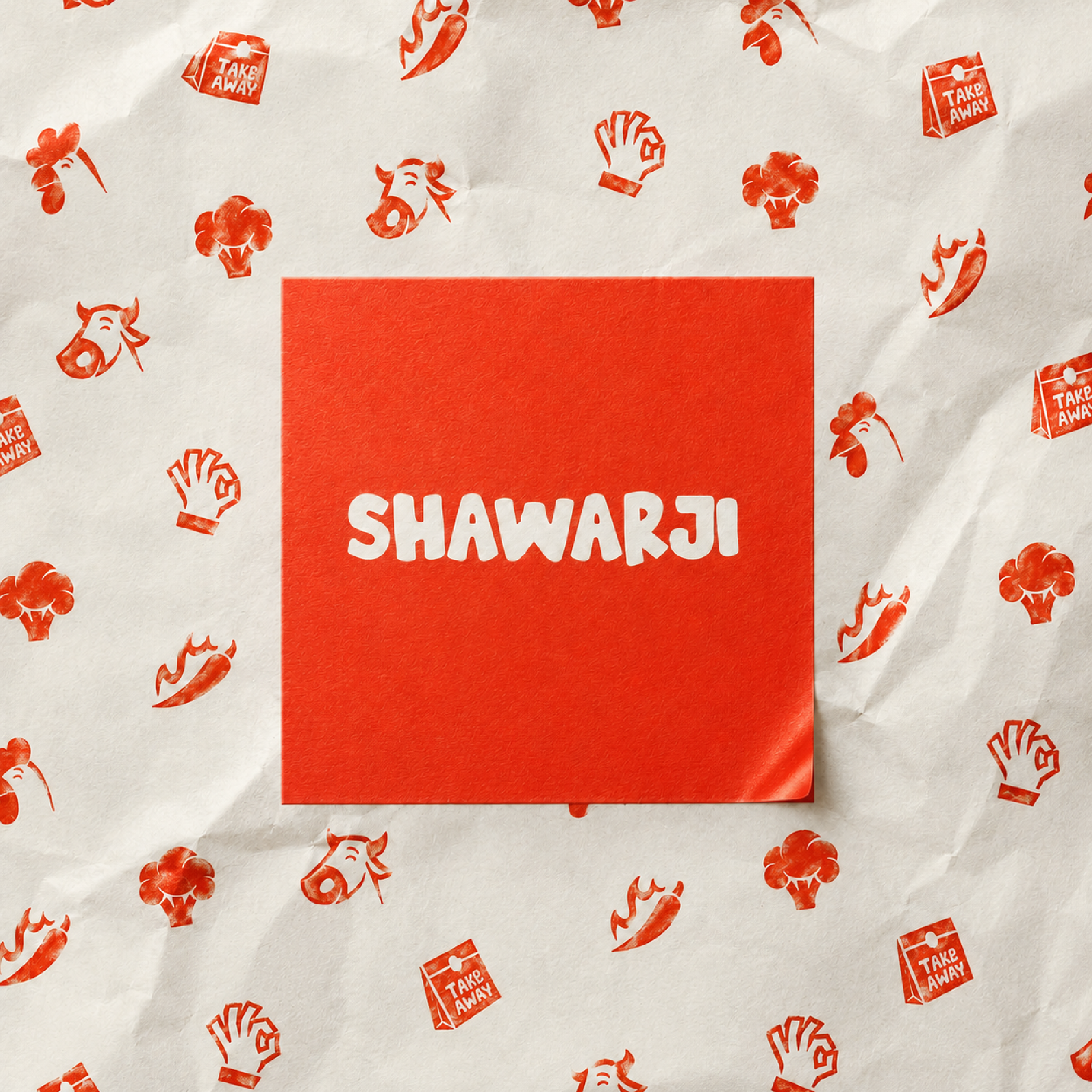 A piece of paper with red patterns of cartoon animal faces, vegetables, and takeout food boxes, partially covering a red box with white text.