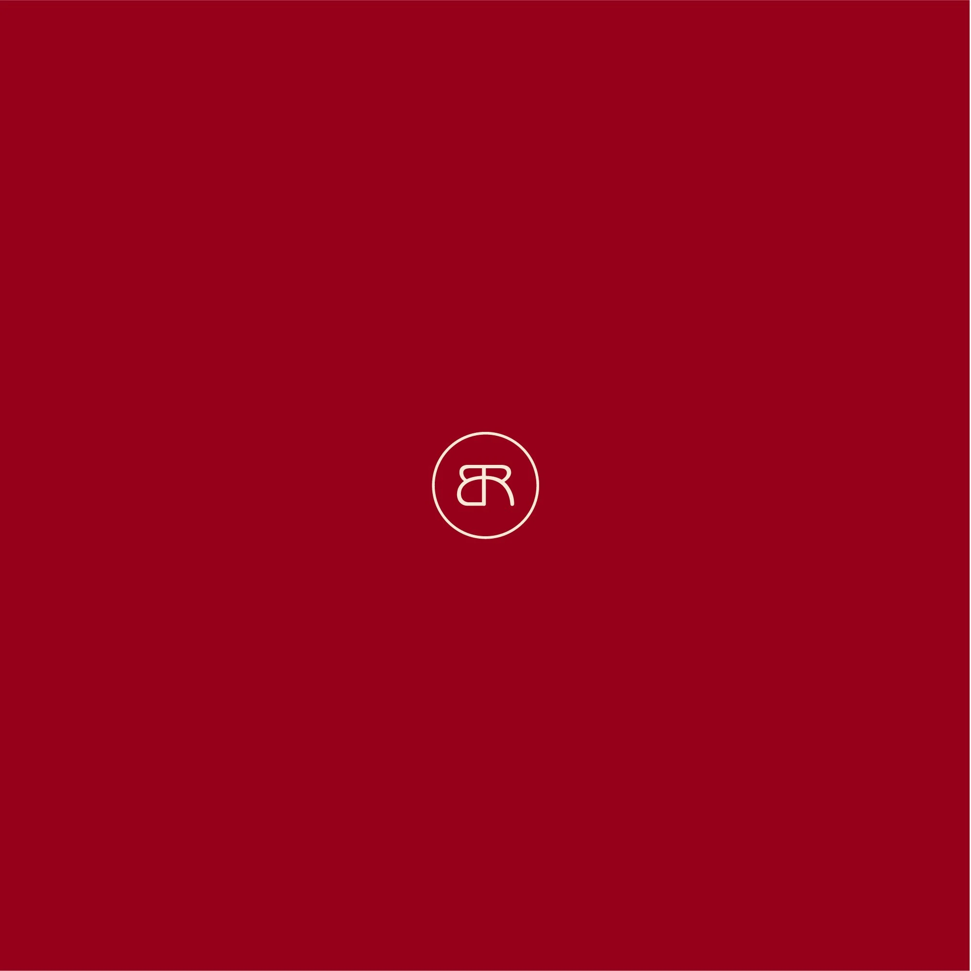 Benge Redding BR monogram displayed on a deep red background as part of the luxury real estate identity system.