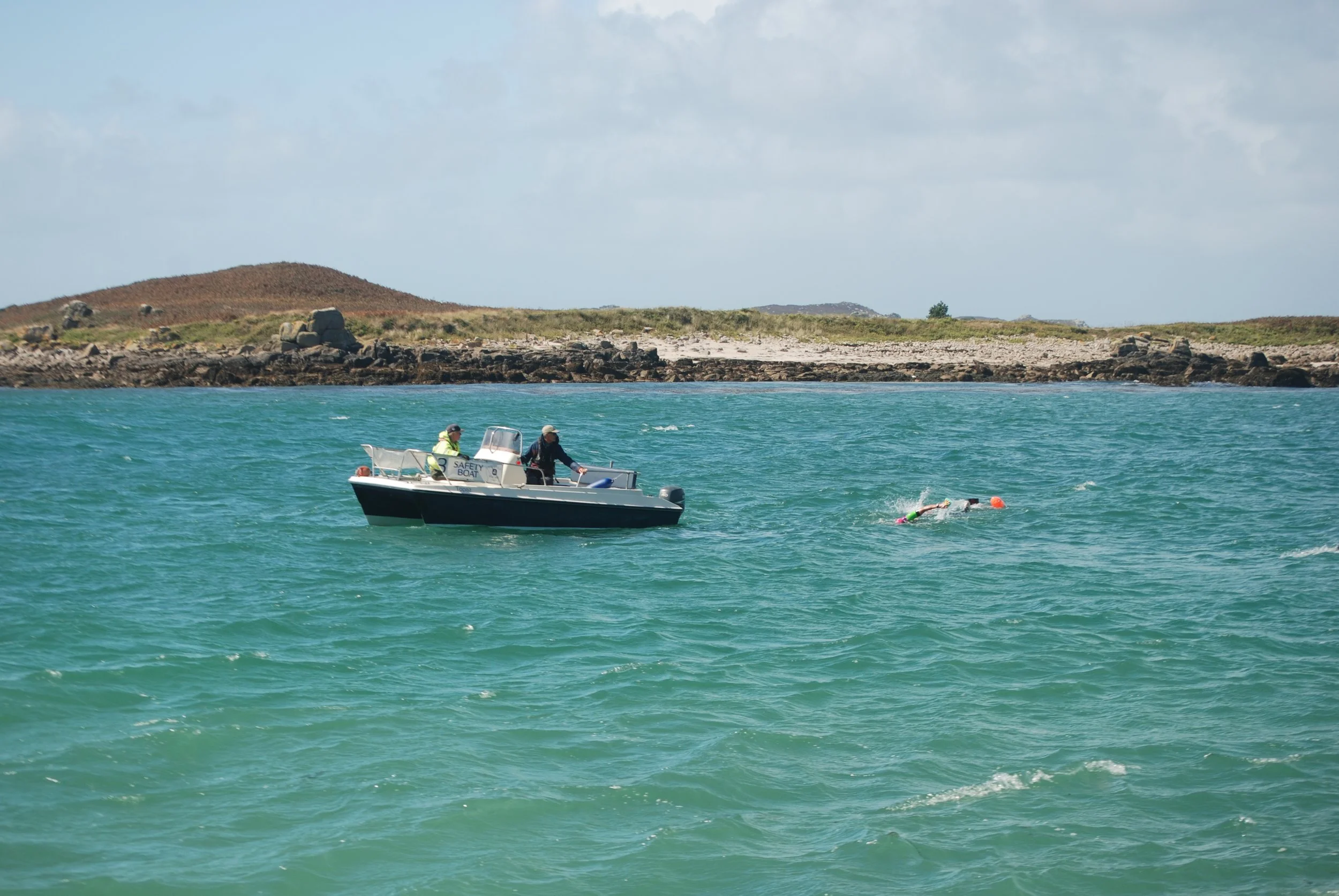 Safety boat watching over swimrun participants