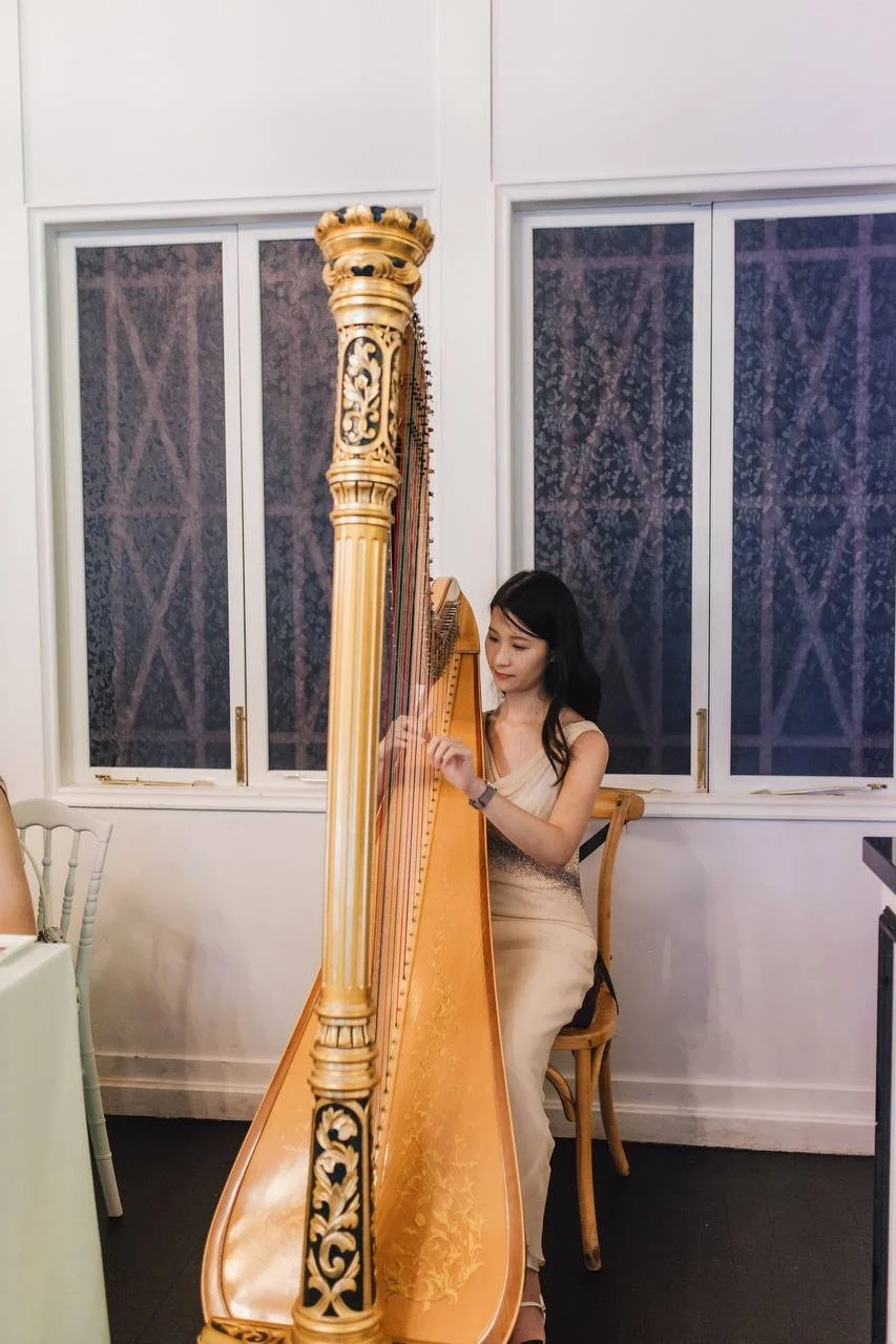 A harpist, Katherine Tay, performing for a wedding held at The Summerhouse, a restaurant in Singapore.