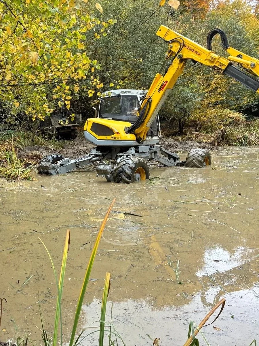 Menzi Muck working in a pond