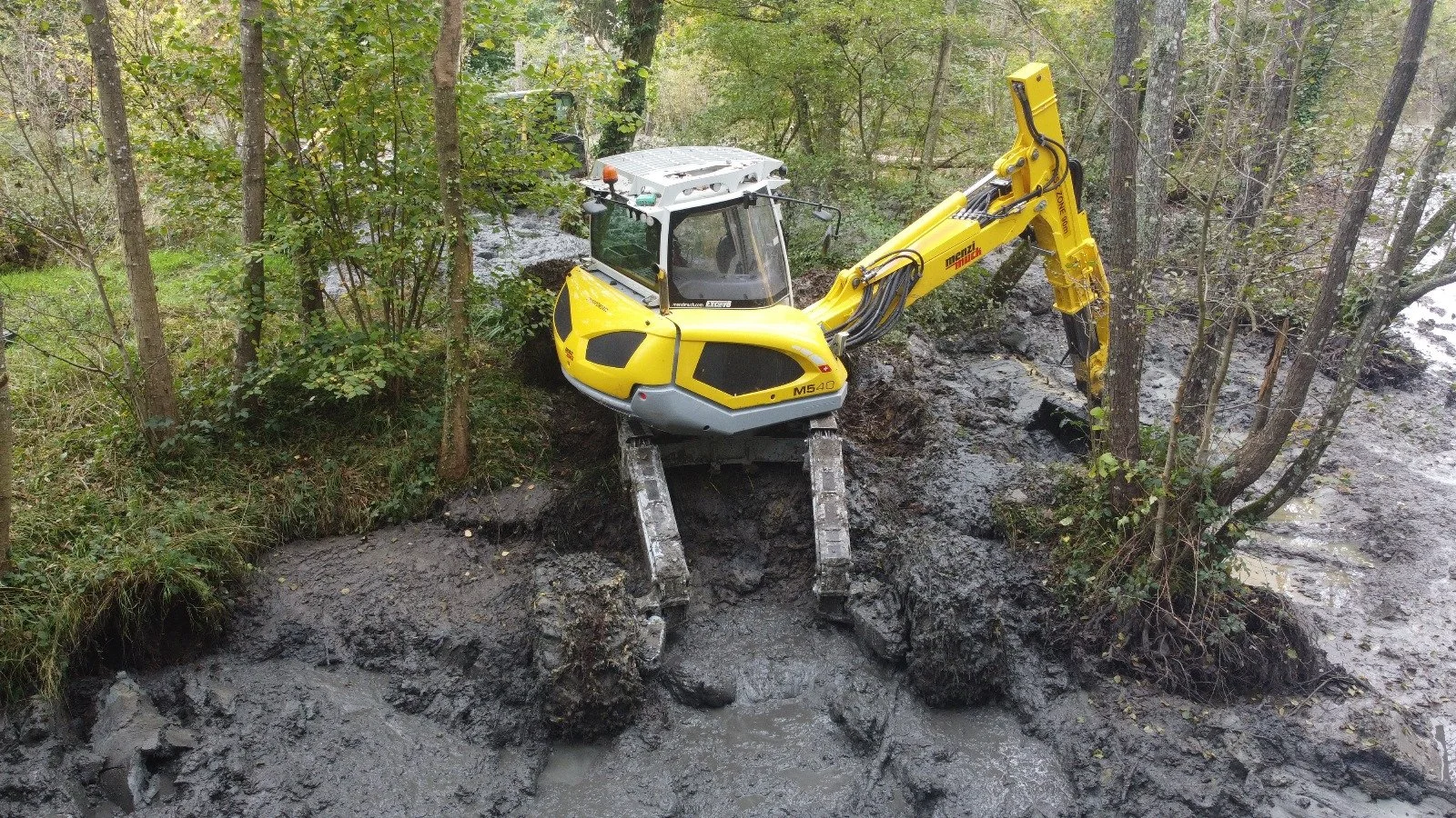 Menzi Muck undertaking lake de-silting work
