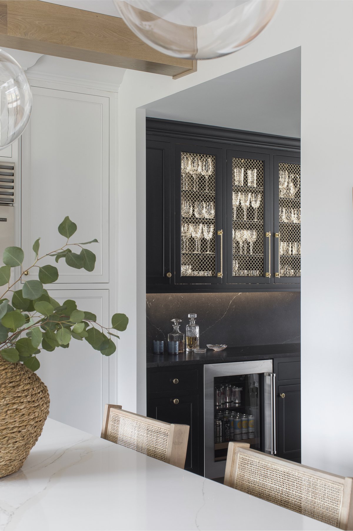 Transitional white inset kitchen with white oak island, professional appliances and a full height backsplash.