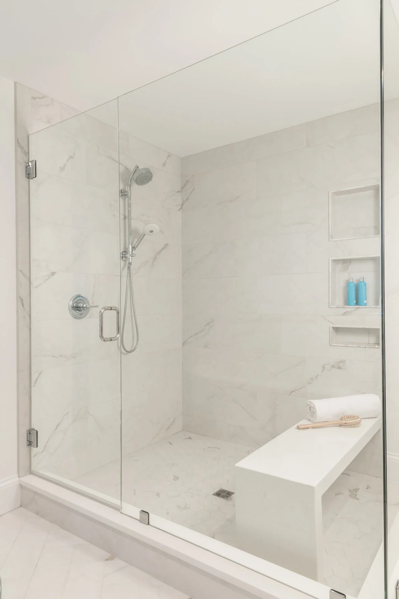 Transitional coastal primary bath with blue-gray cabinets, freestanding tub and walk in shower. 
