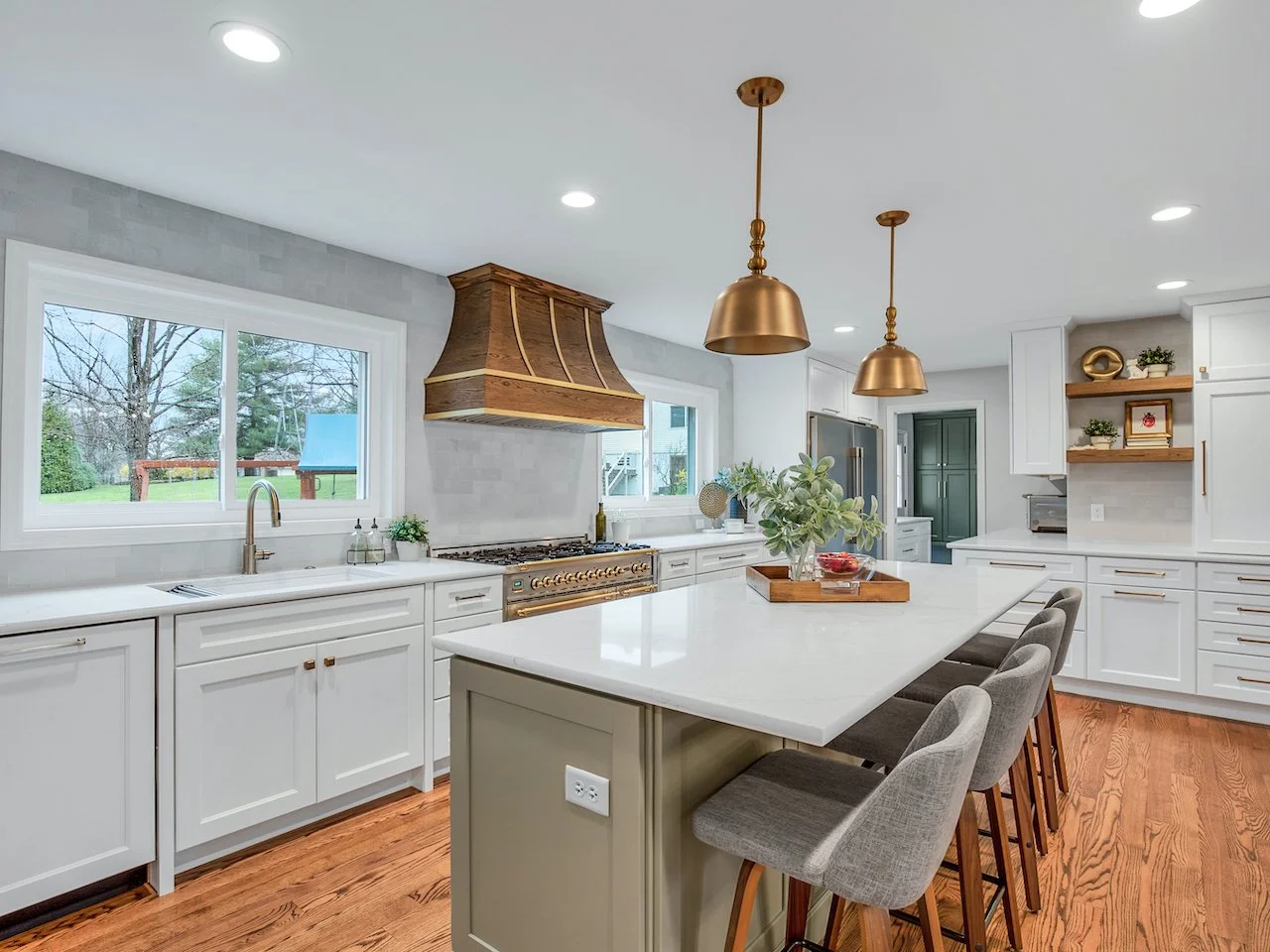 Transitional white kitchen with quartz countertops and tile splash. 