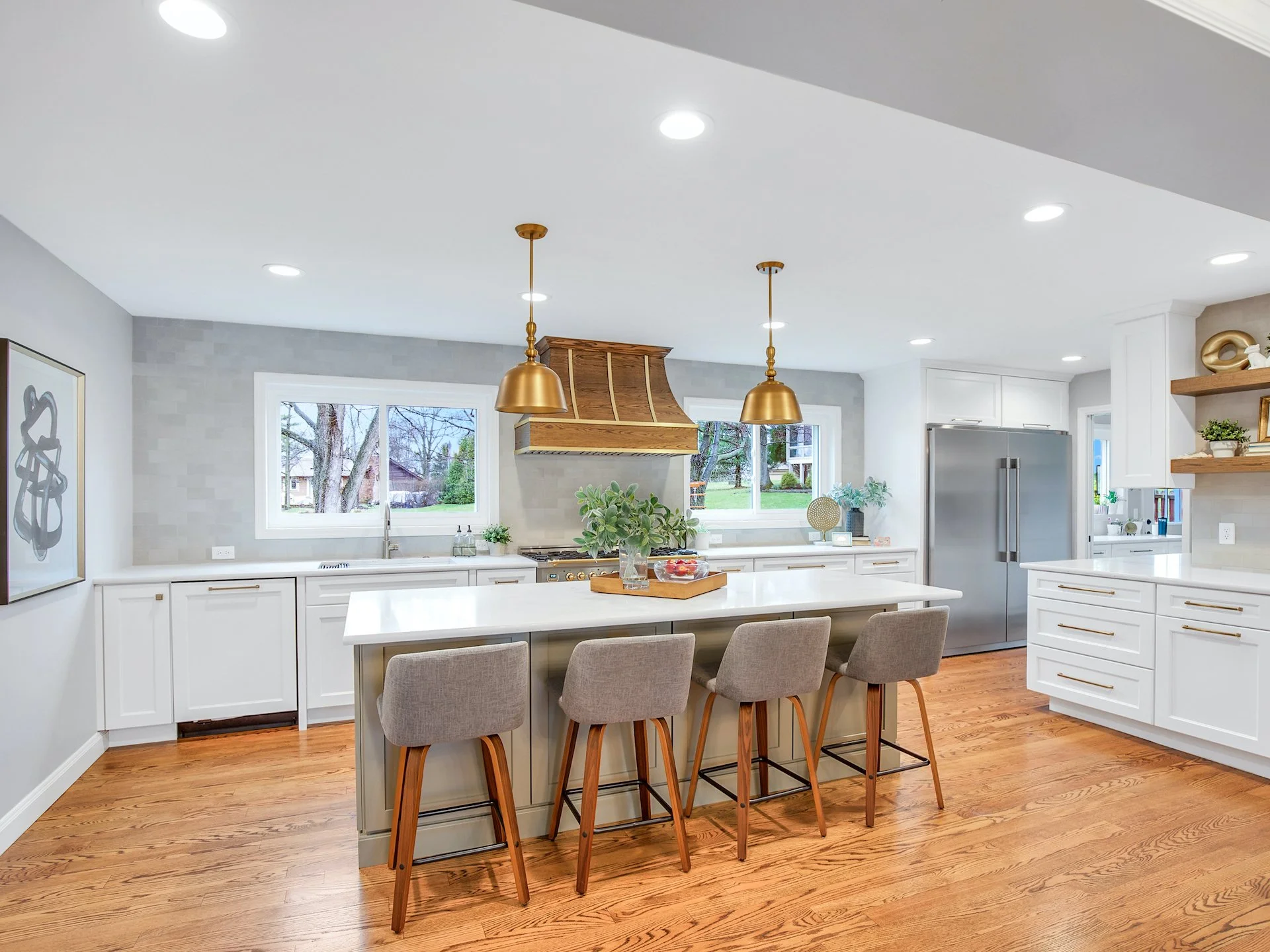 Transitional white kitchen with quartz countertops and tile splash. 