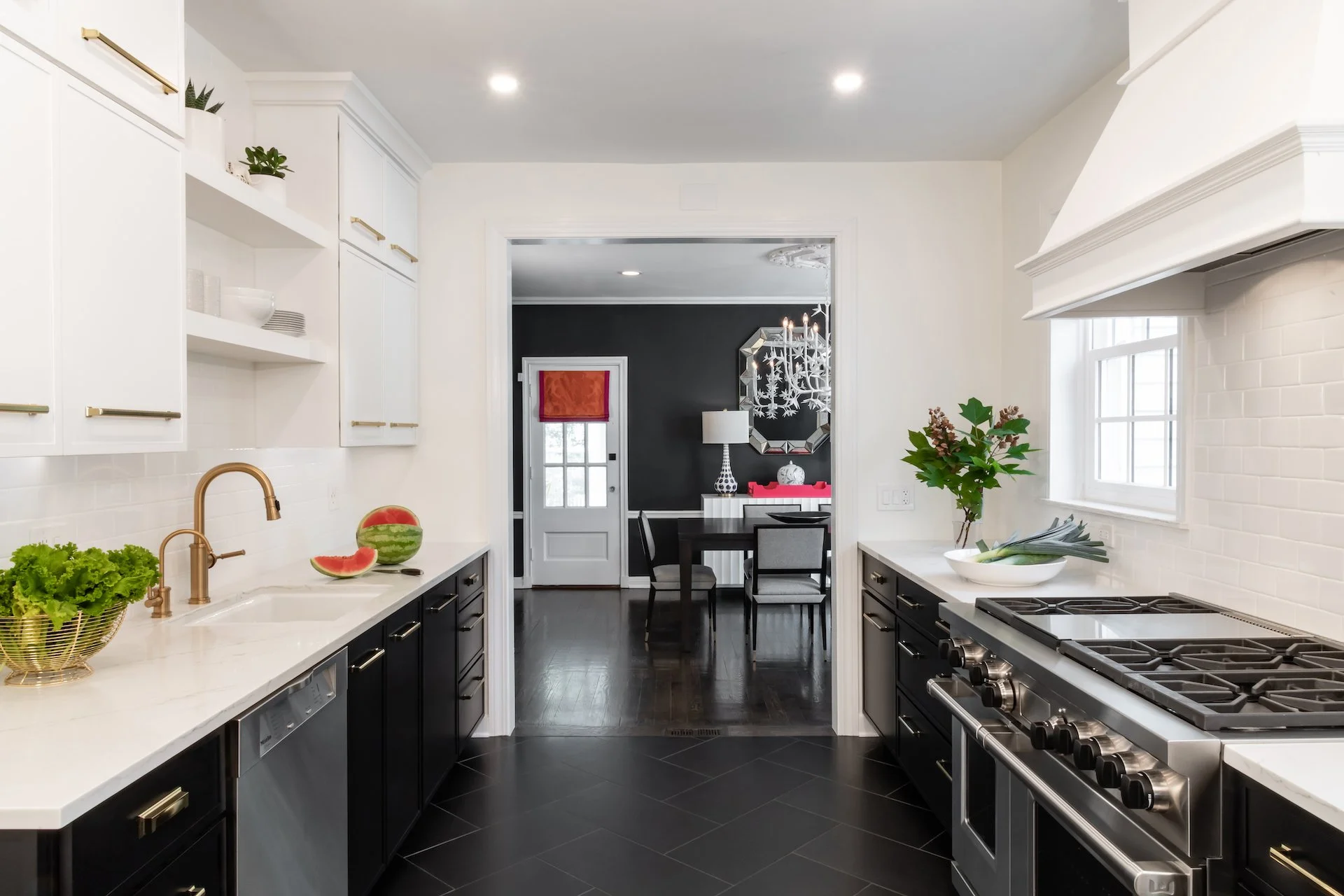 Modern kitchen in a traditional home. Black and white cabinetry and gold fixtures make this kitchen classic while updated and modern. 