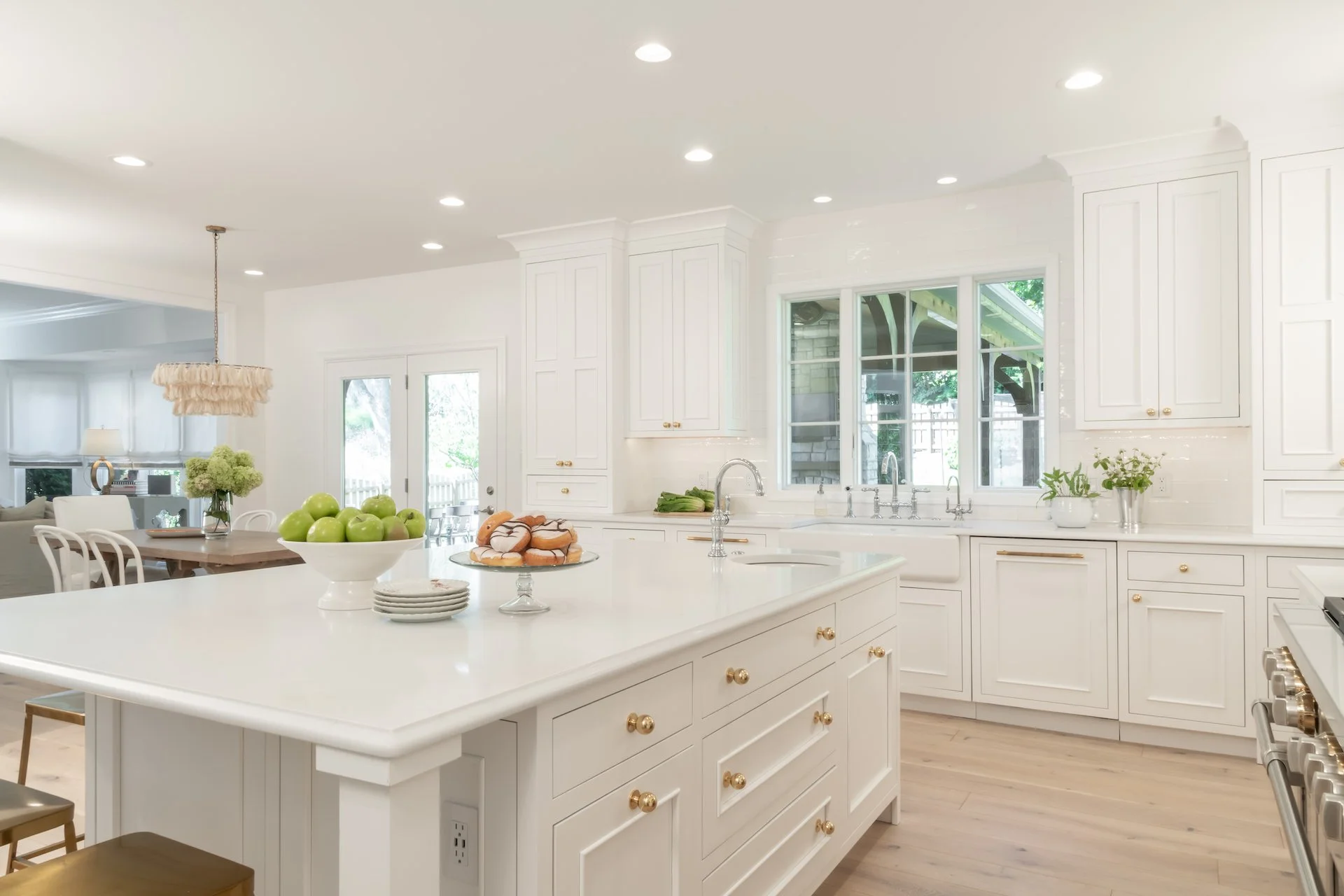 Transitional white inset kitchen with blue bar, professional appliances and brass fixtures. 