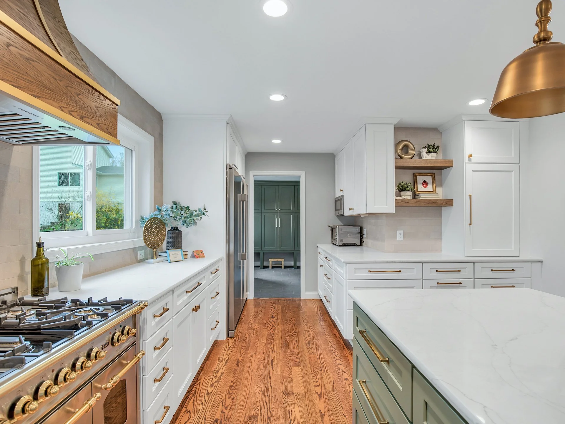 Transitional white kitchen with quartz countertops and tile splash. 