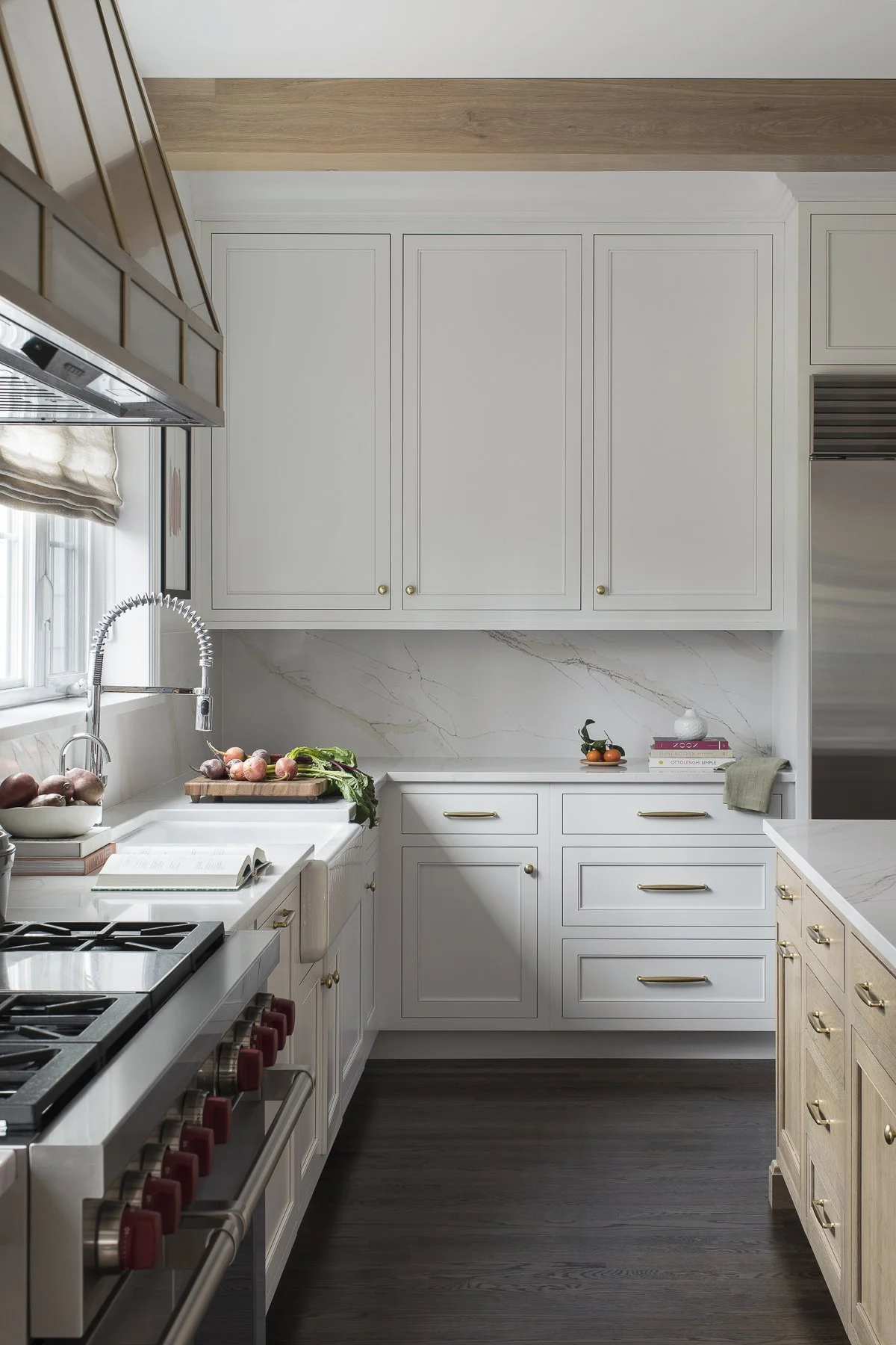 Transitional white inset kitchen with white oak island, professional appliances and a full height backsplash.