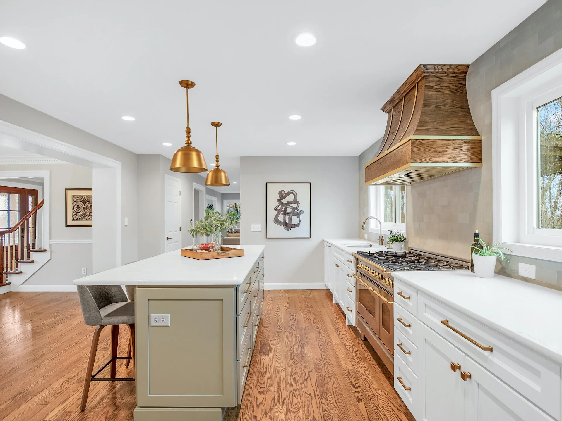 Transitional white kitchen with quartz countertops and tile splash. 