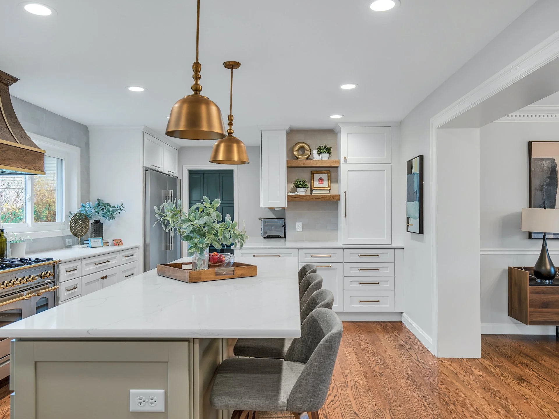 Transitional white kitchen with quartz countertops and tile splash. 