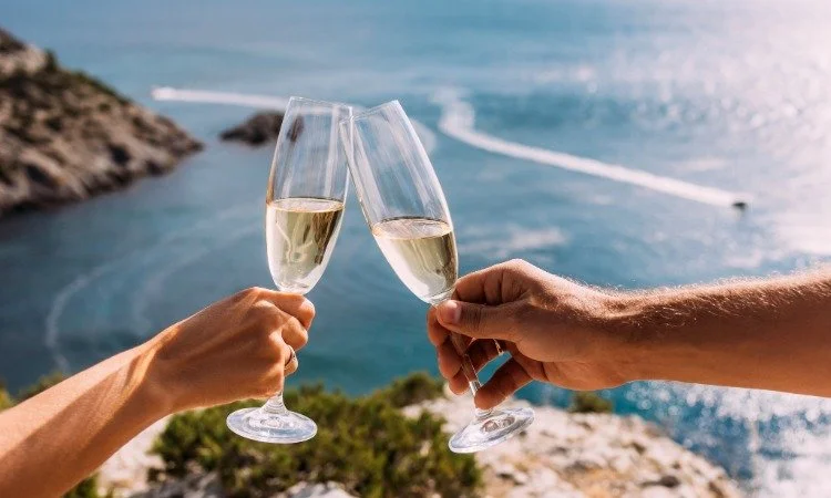 Champagne Toast Over Turquoise Ocean on a Romantic Getaway.jpeg