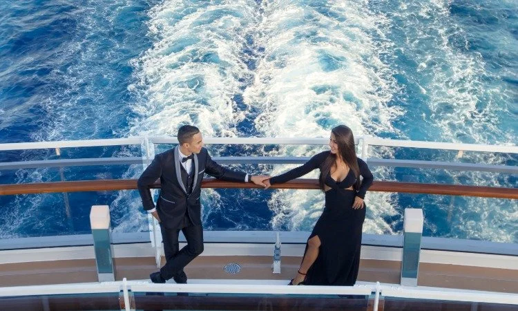 Elegant Couple Holding Hands on a Cruise Ship Deck.jpeg