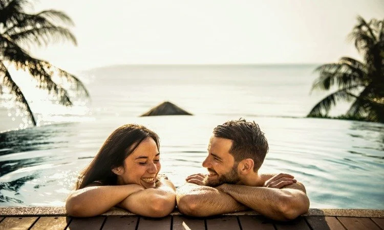 Joyful Couple Relaxing in a Tropical Infinity Pool.jpeg