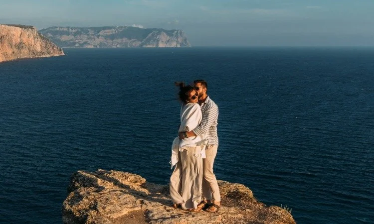 Romantic Cliffside Embrace Overlooking the Ocean.jpeg