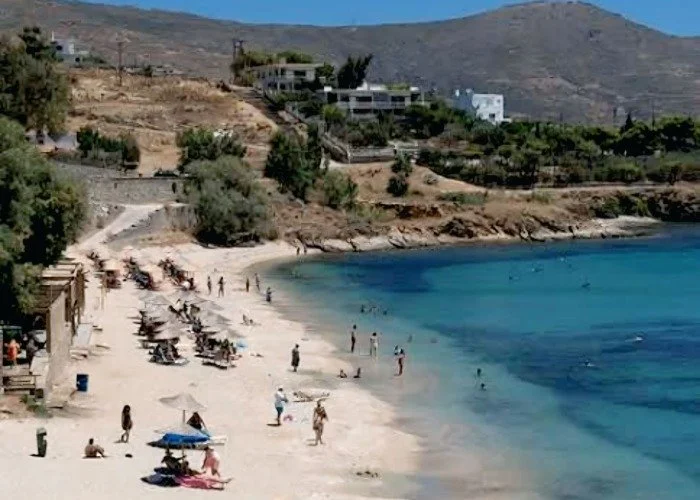 Agia Paraskevi Beach Karystos with umbellas and swimmers.jpeg