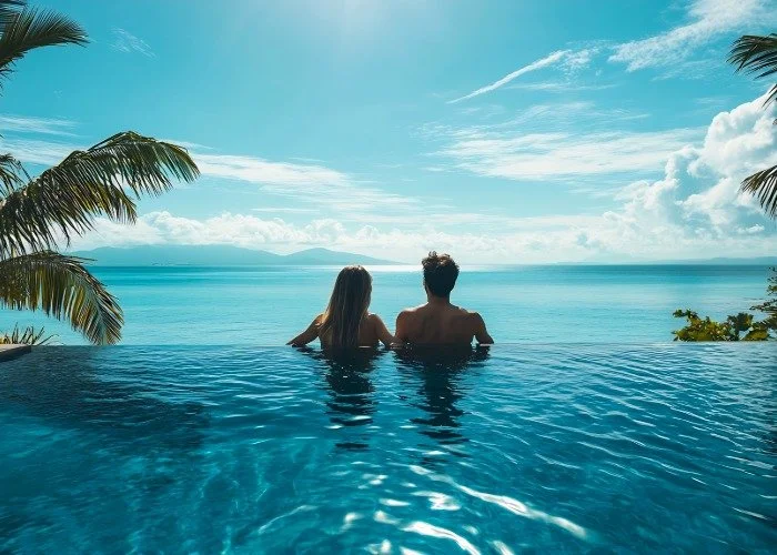Couple enjoys infinity pool overlooking ocean vista.jpeg