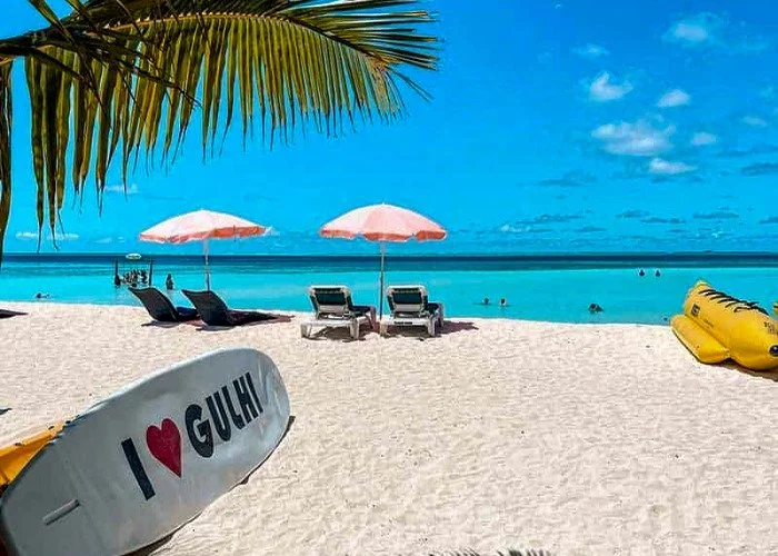Tropical beach scene with lounge chairs and turquoise water.jpeg