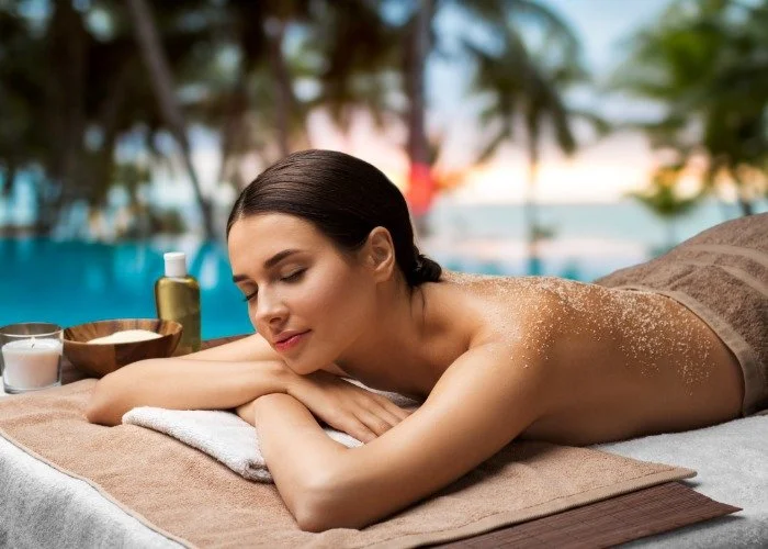Woman receiving a spa treatment outdoors with palm trees.jpeg