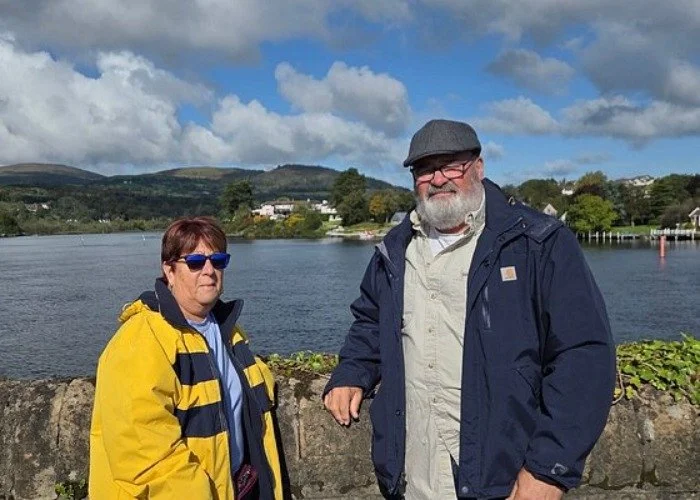 travelers posing by scenic lake and mountains.jpg