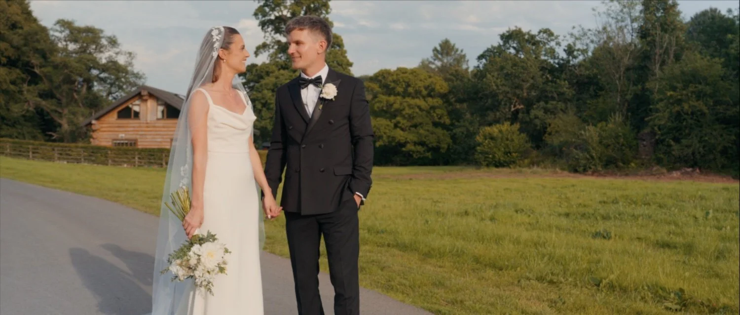 Newlyweds celebrating their wedding at Hidden River Barn in Cumbria.