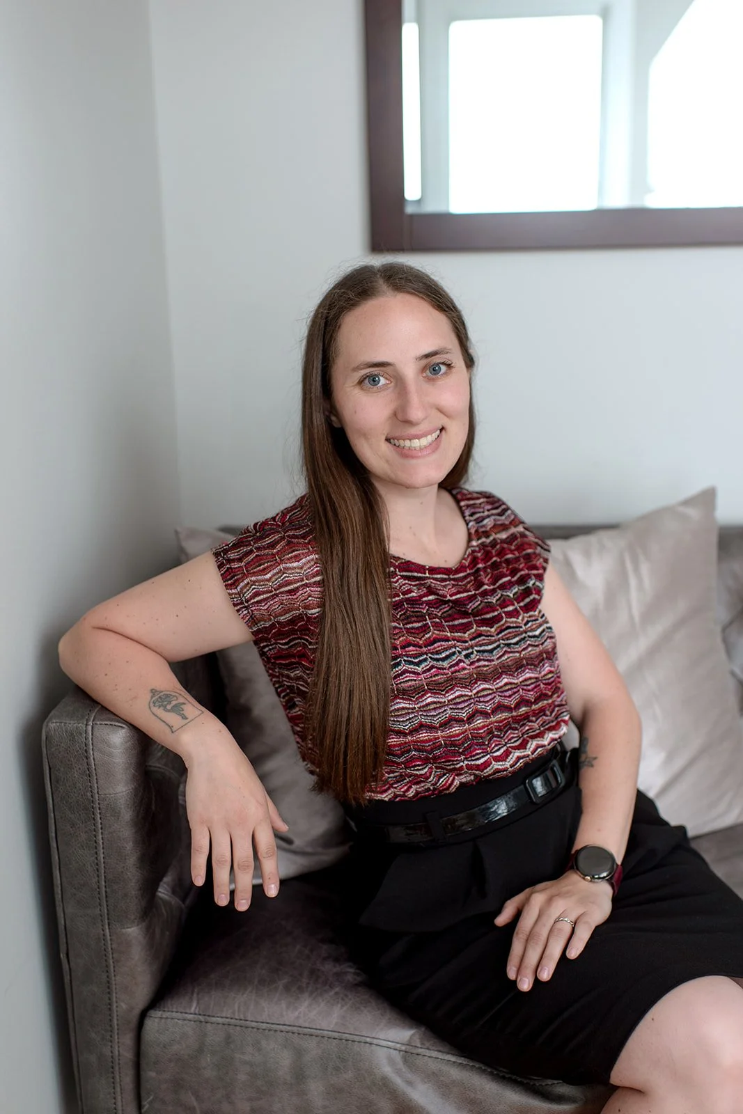 Certified Birth Doula Lacy Anderson poses for professional photoshoot in Marquette home.