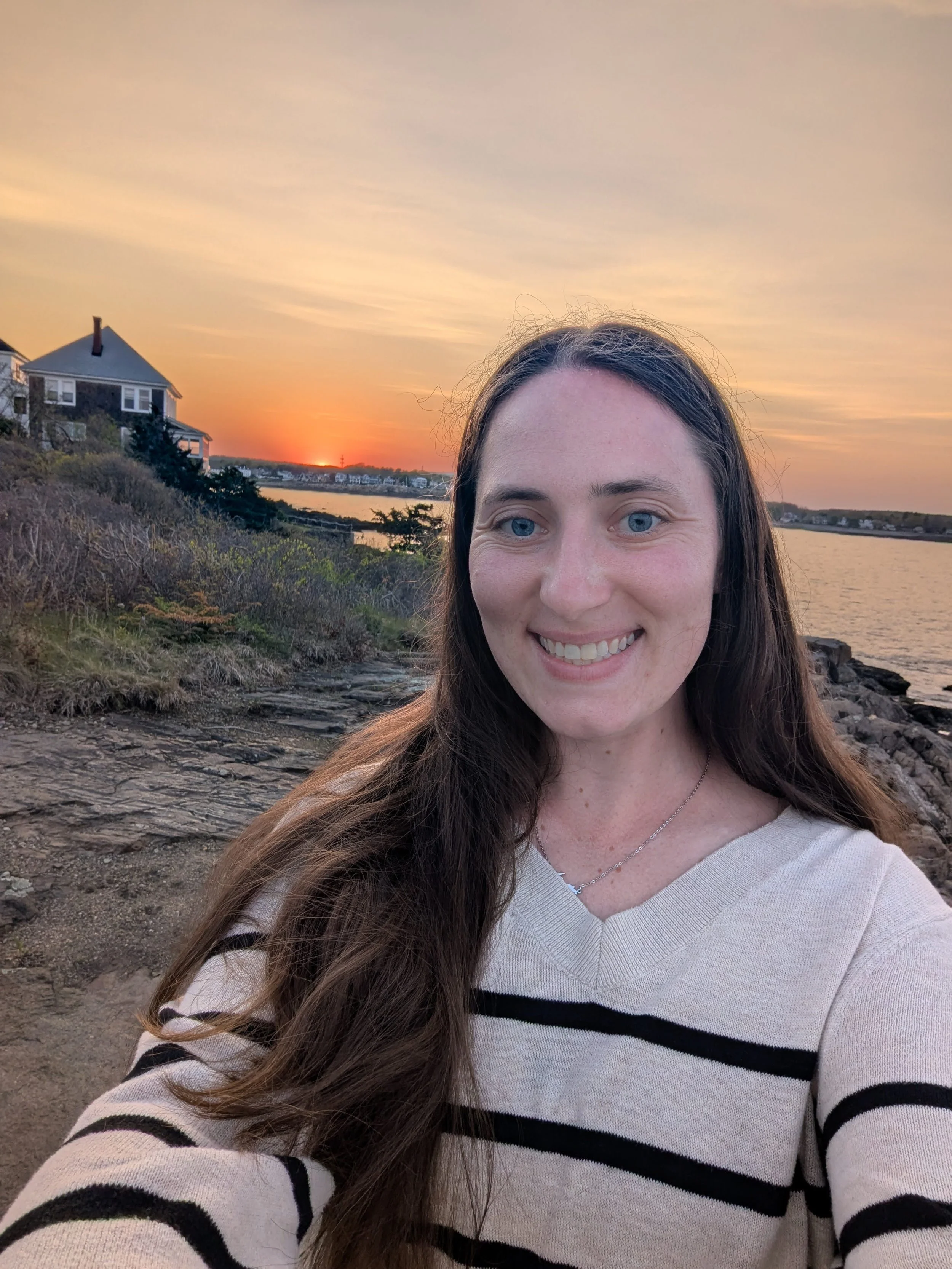 Certified childbirth educator and doula lacy anderson on the water with a beautiful sun set in the back ground