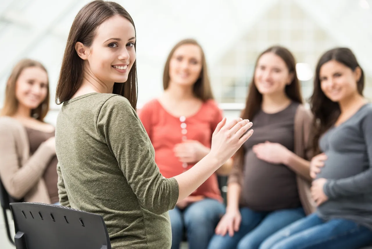 A group of pregnant women pose for photo during free childbirth education class in Marquette.